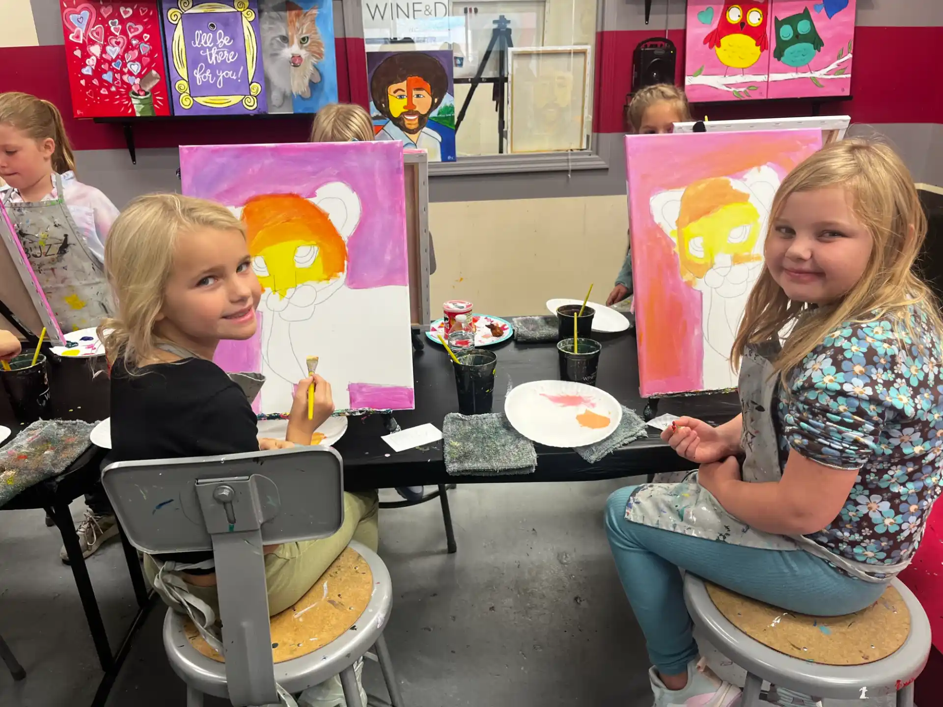 a group of children sitting at a table eating food