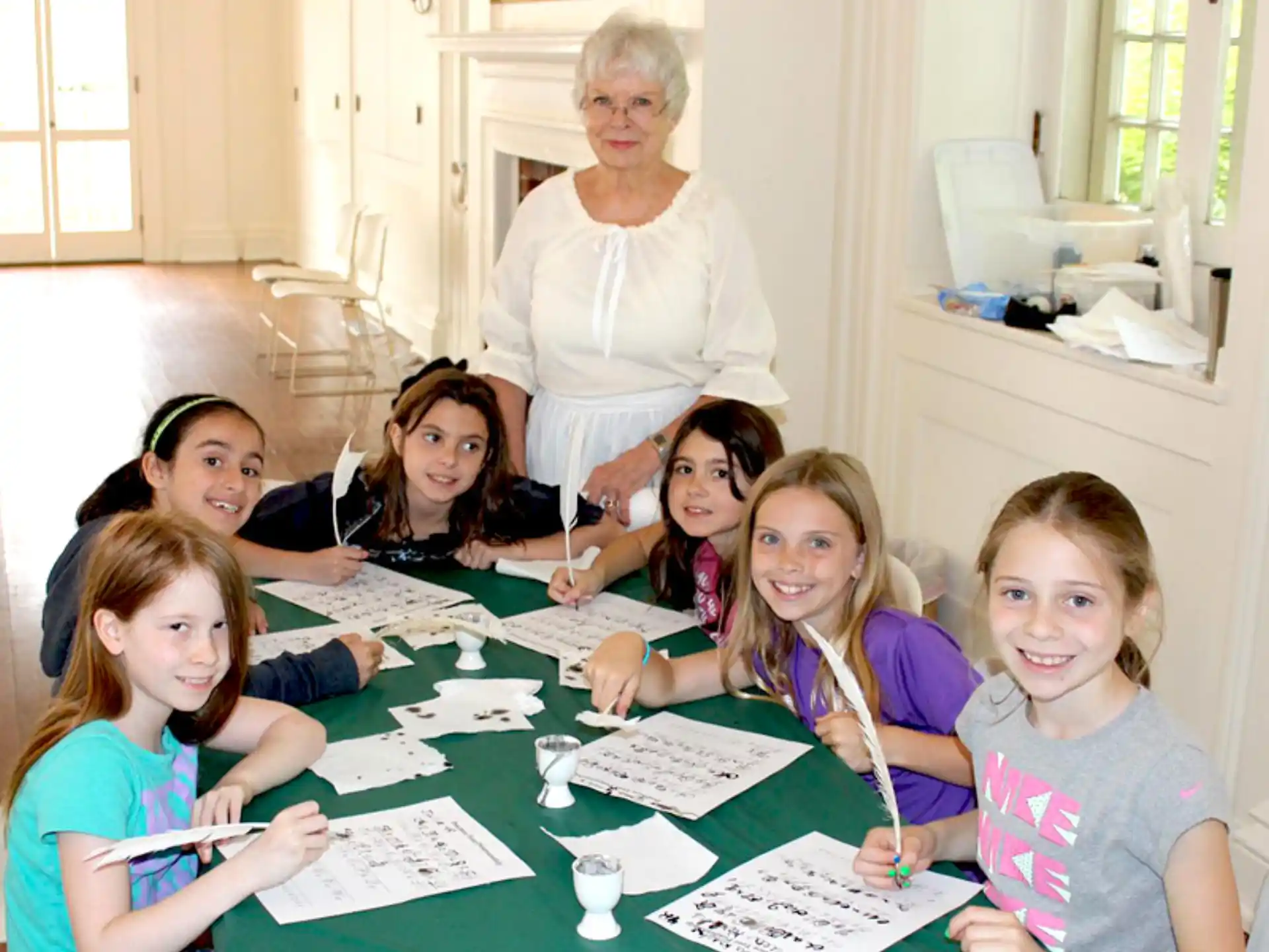 a group of children sitting around a table
