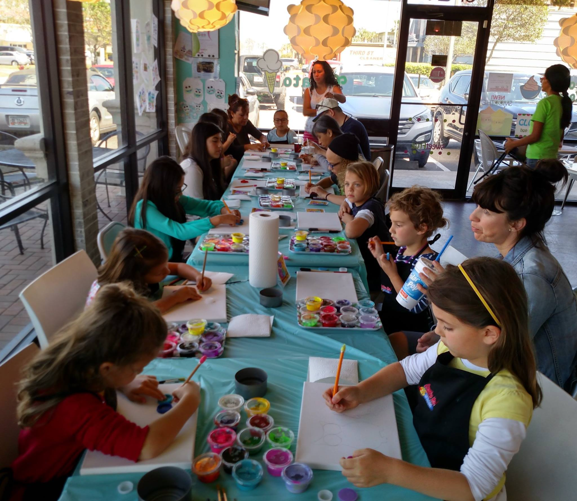 a group of children sitting around a table