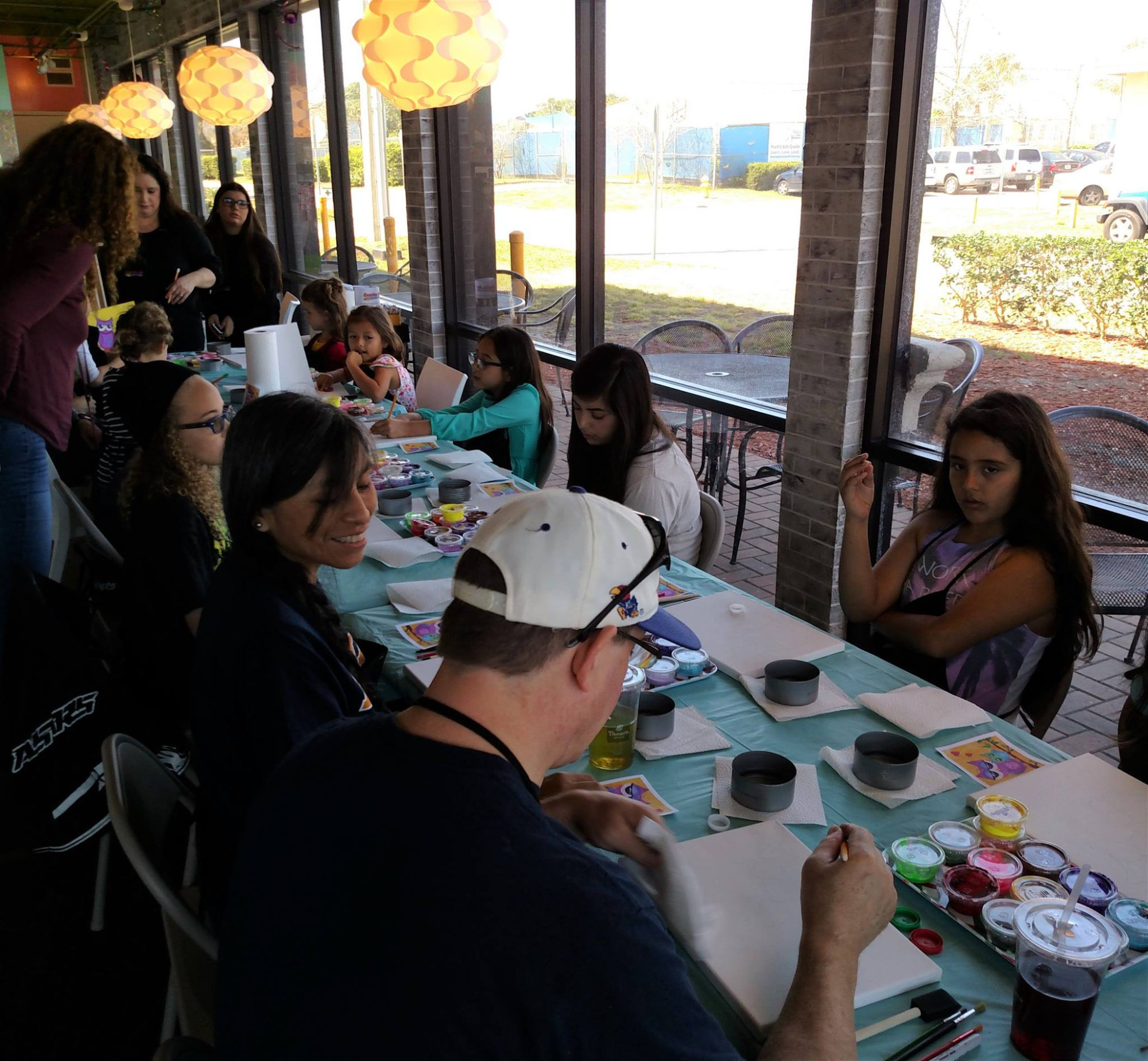 a group of people sitting at a table eating food