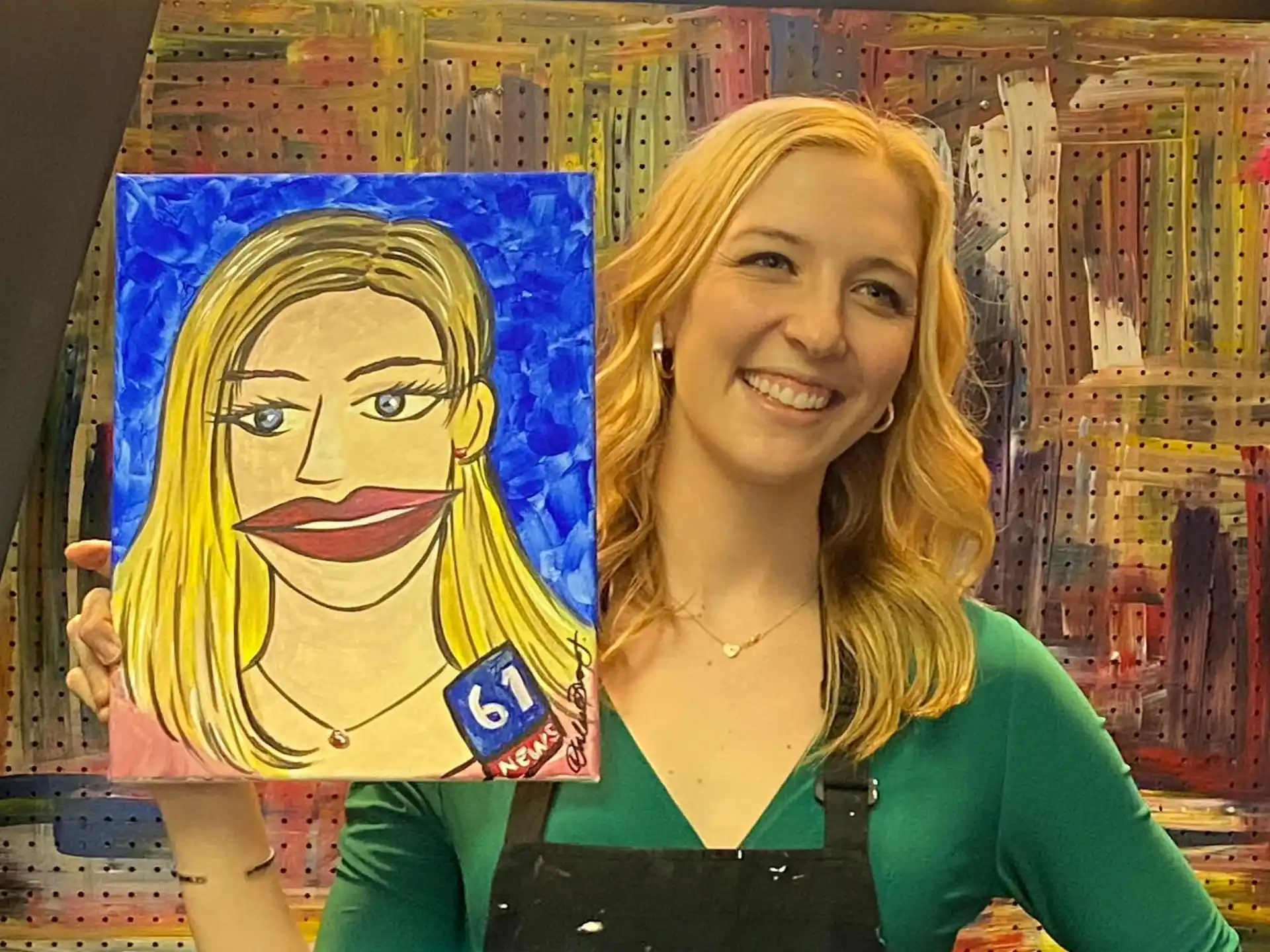 a woman standing next to a painting
