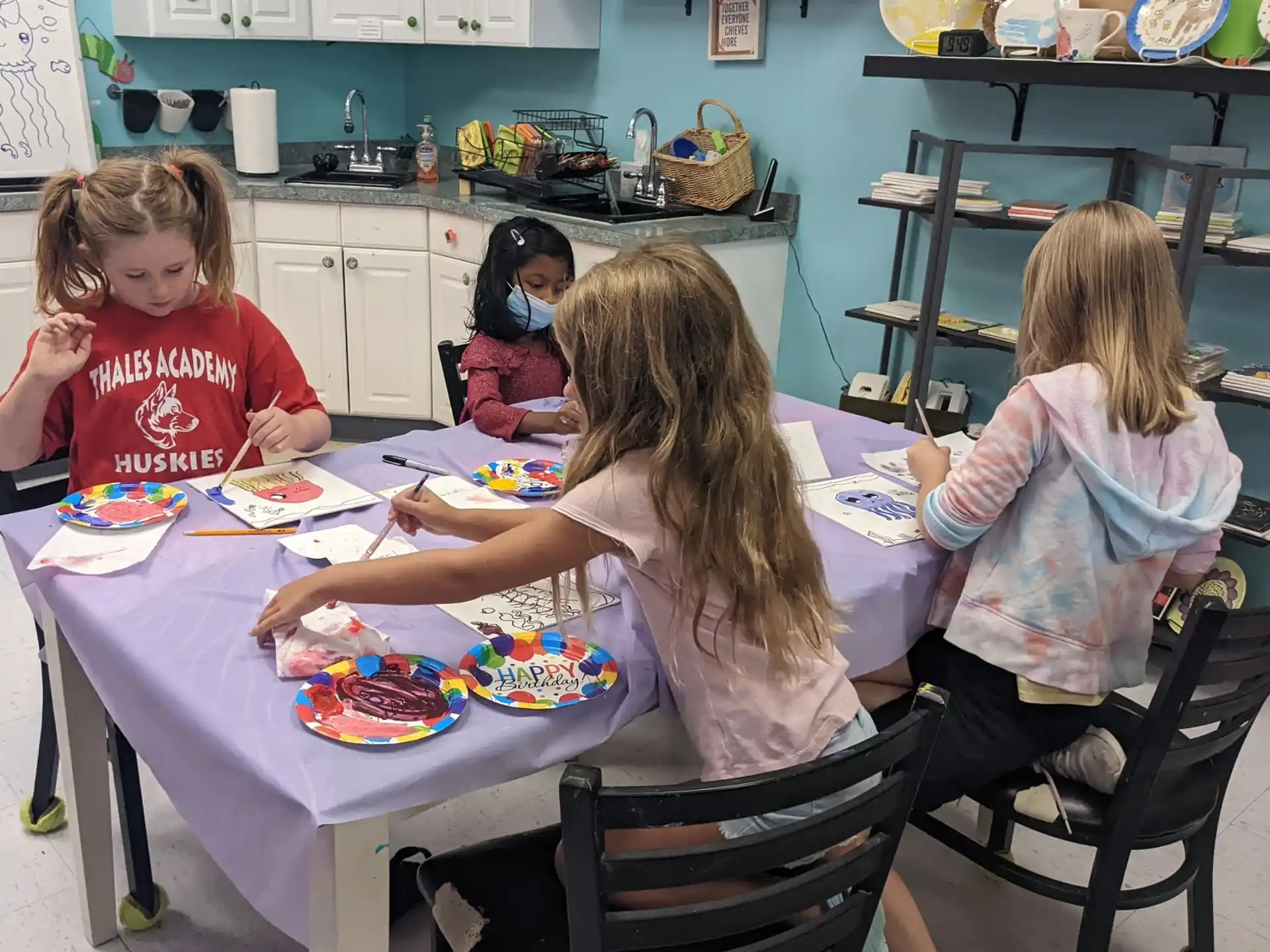 a group of children sitting at a table