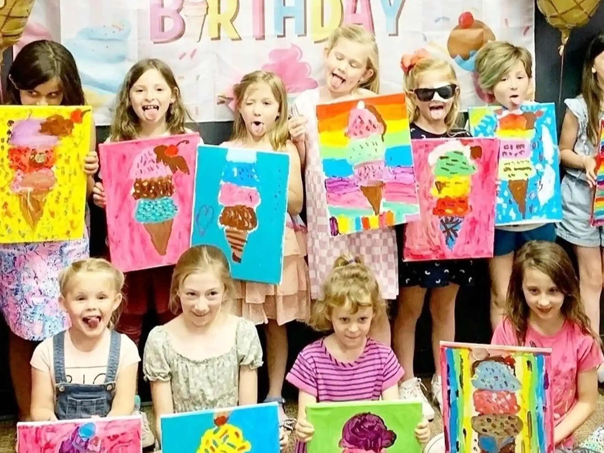 a group of children holding up colorful paper