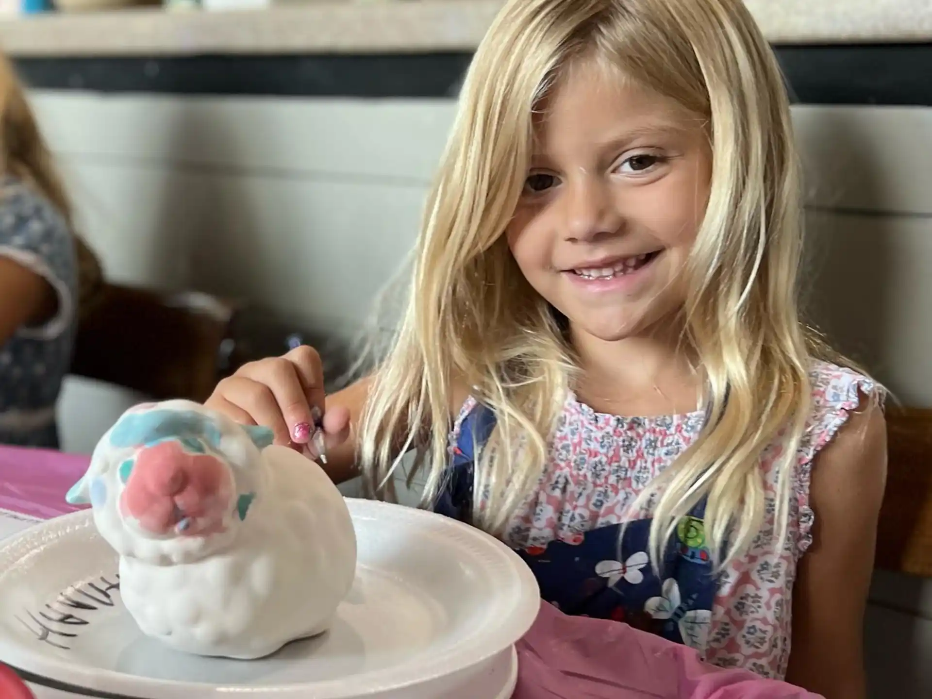 a girl holding a cupcake
