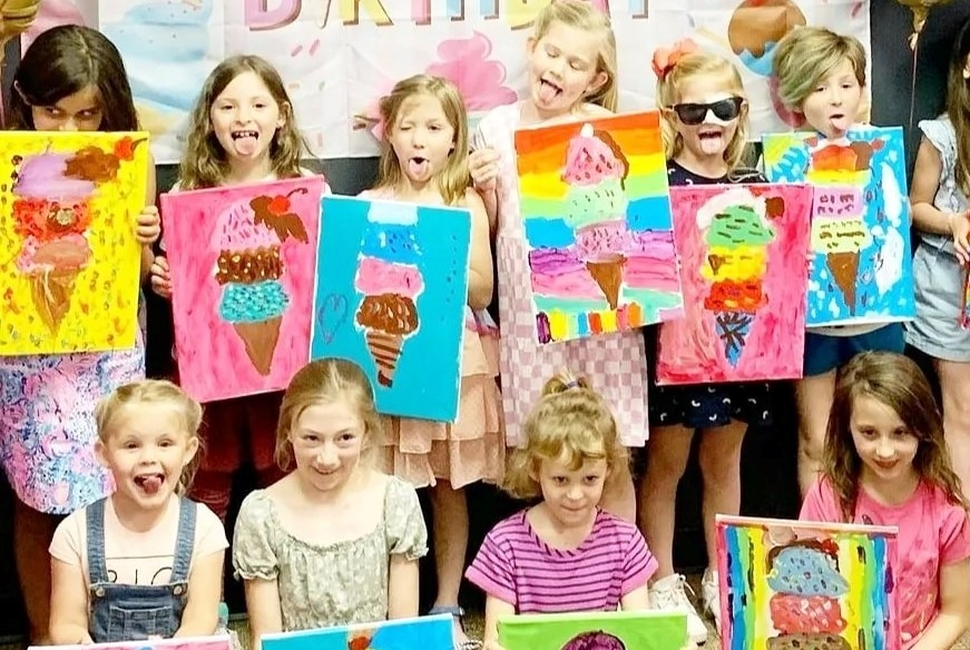 a group of children holding up colorful paper signs