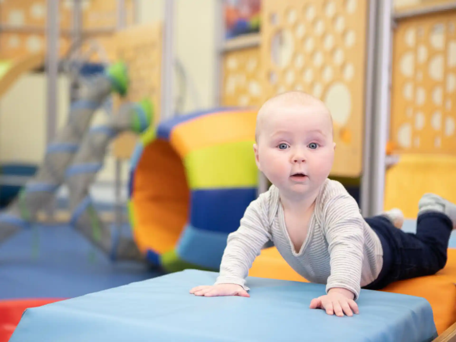 a baby sitting on a blue chair