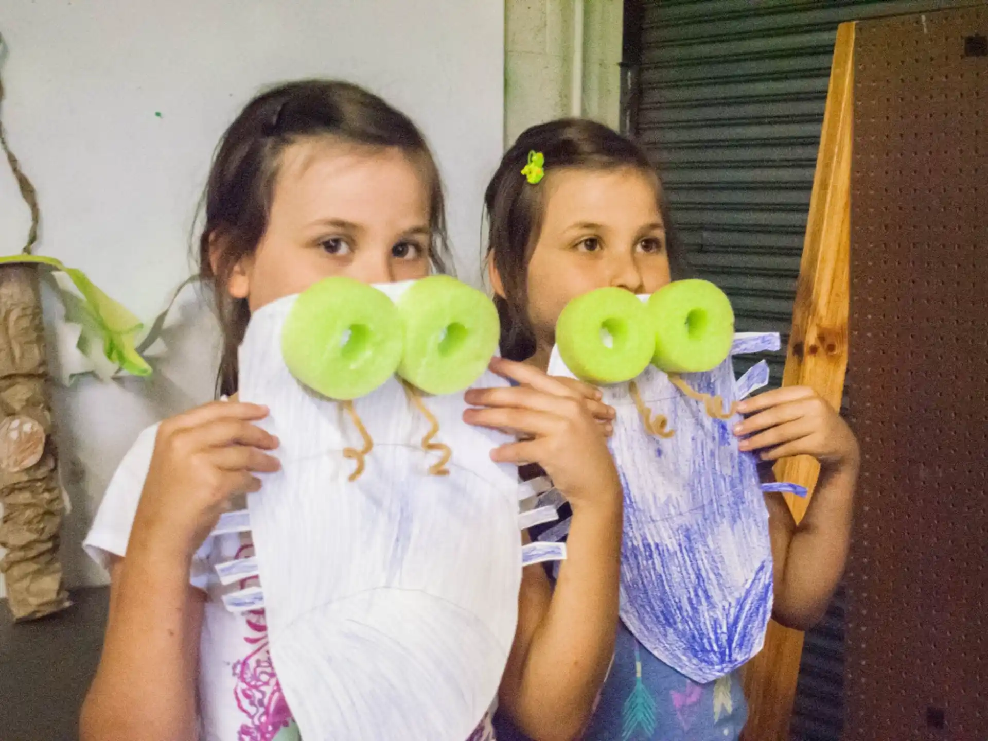 a couple of girls holding green apples