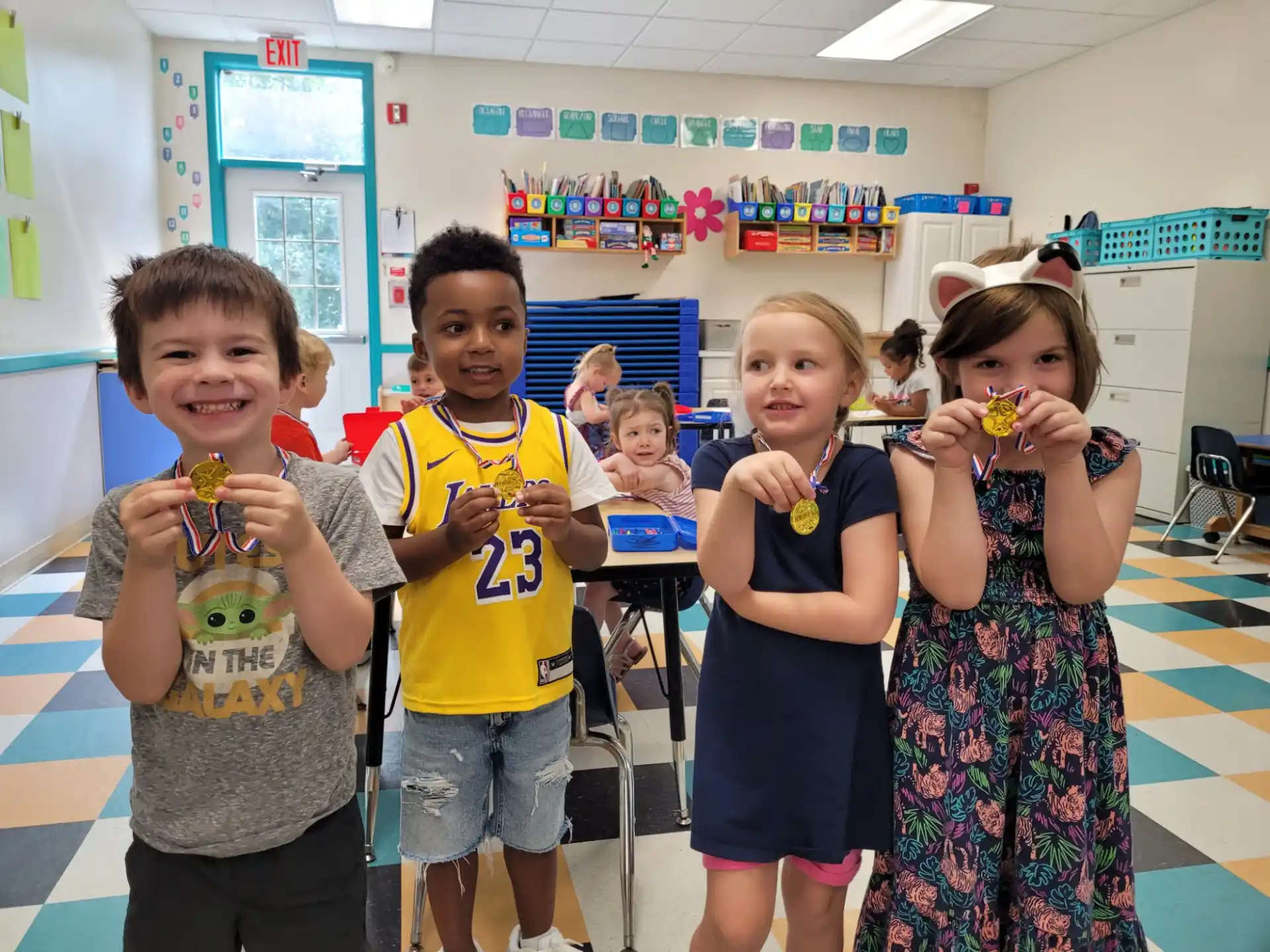 a group of children holding objects posing for the camera