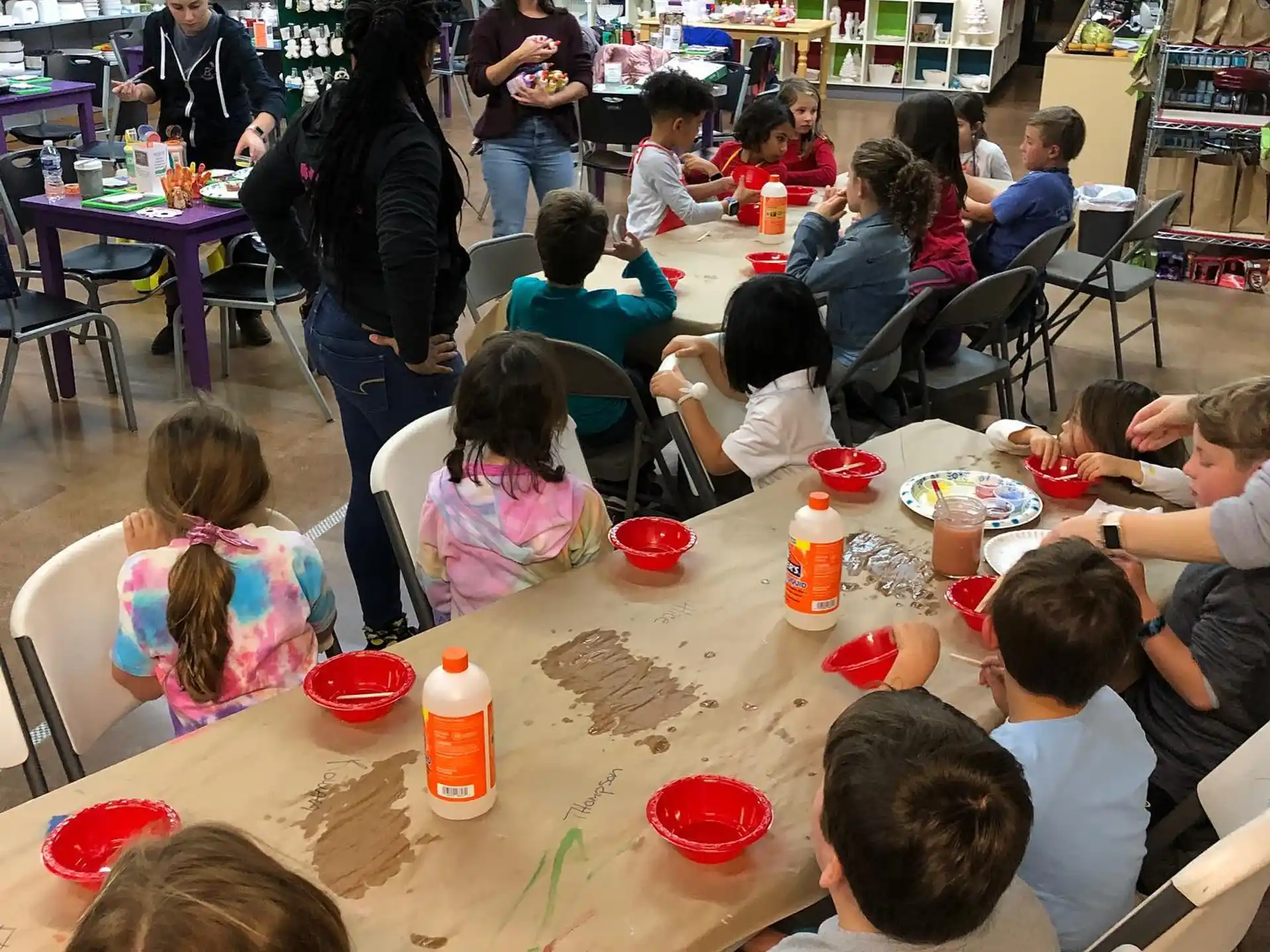 a group of people sitting around a table with food on it