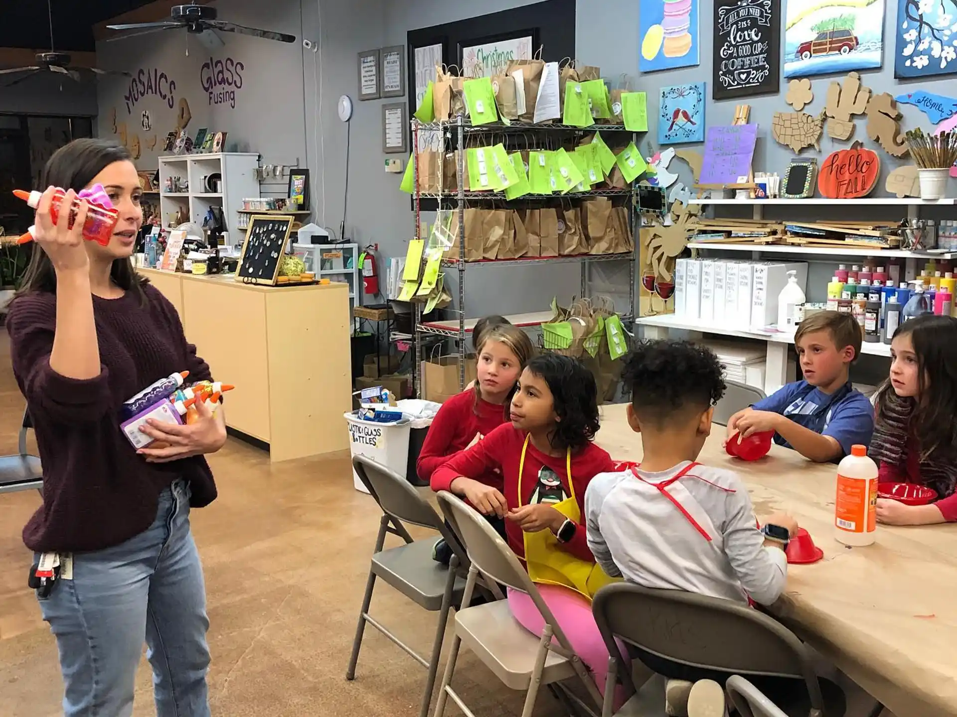 a person standing in front of a classroom of children
