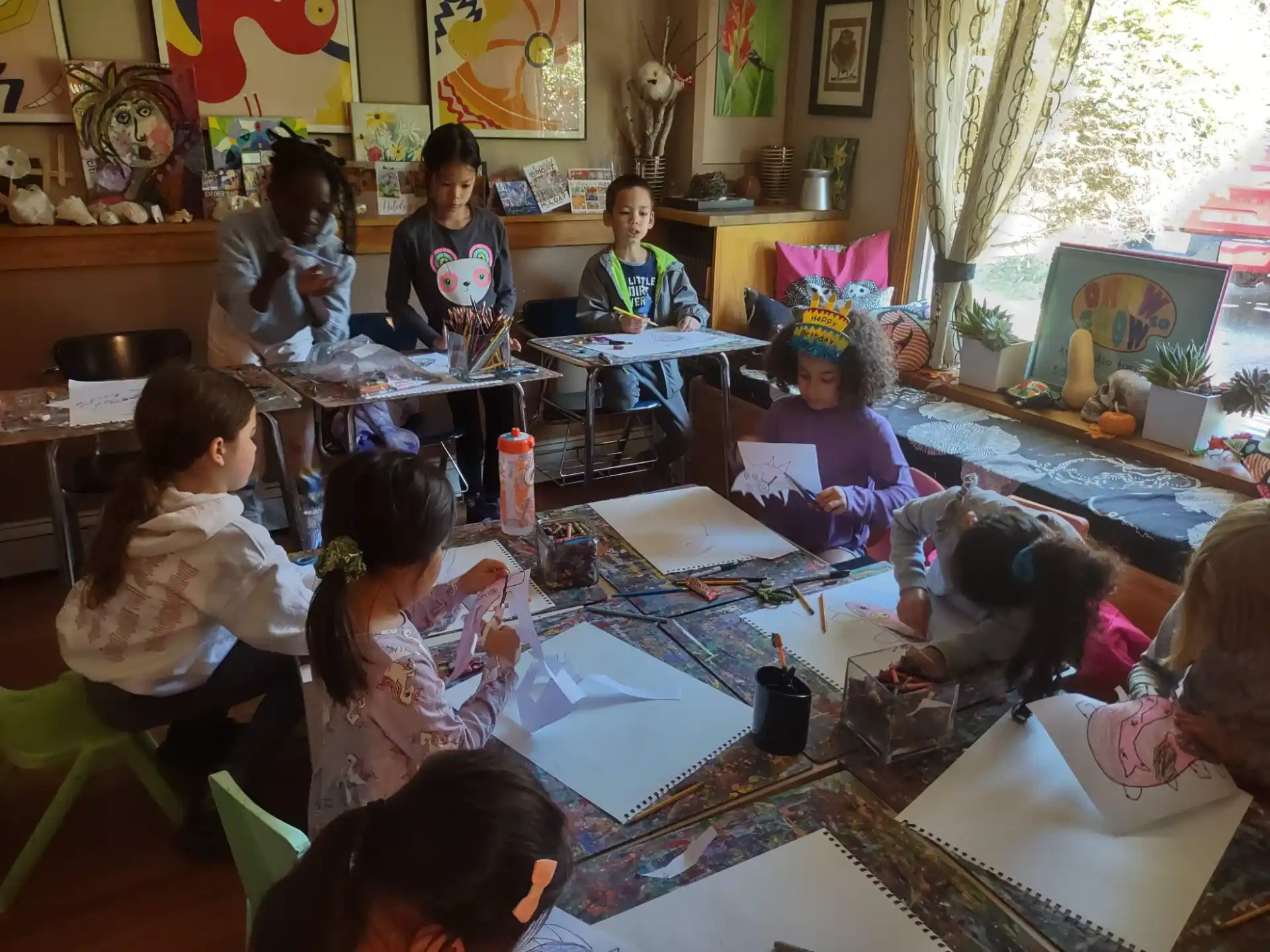 a group of children sitting around a table