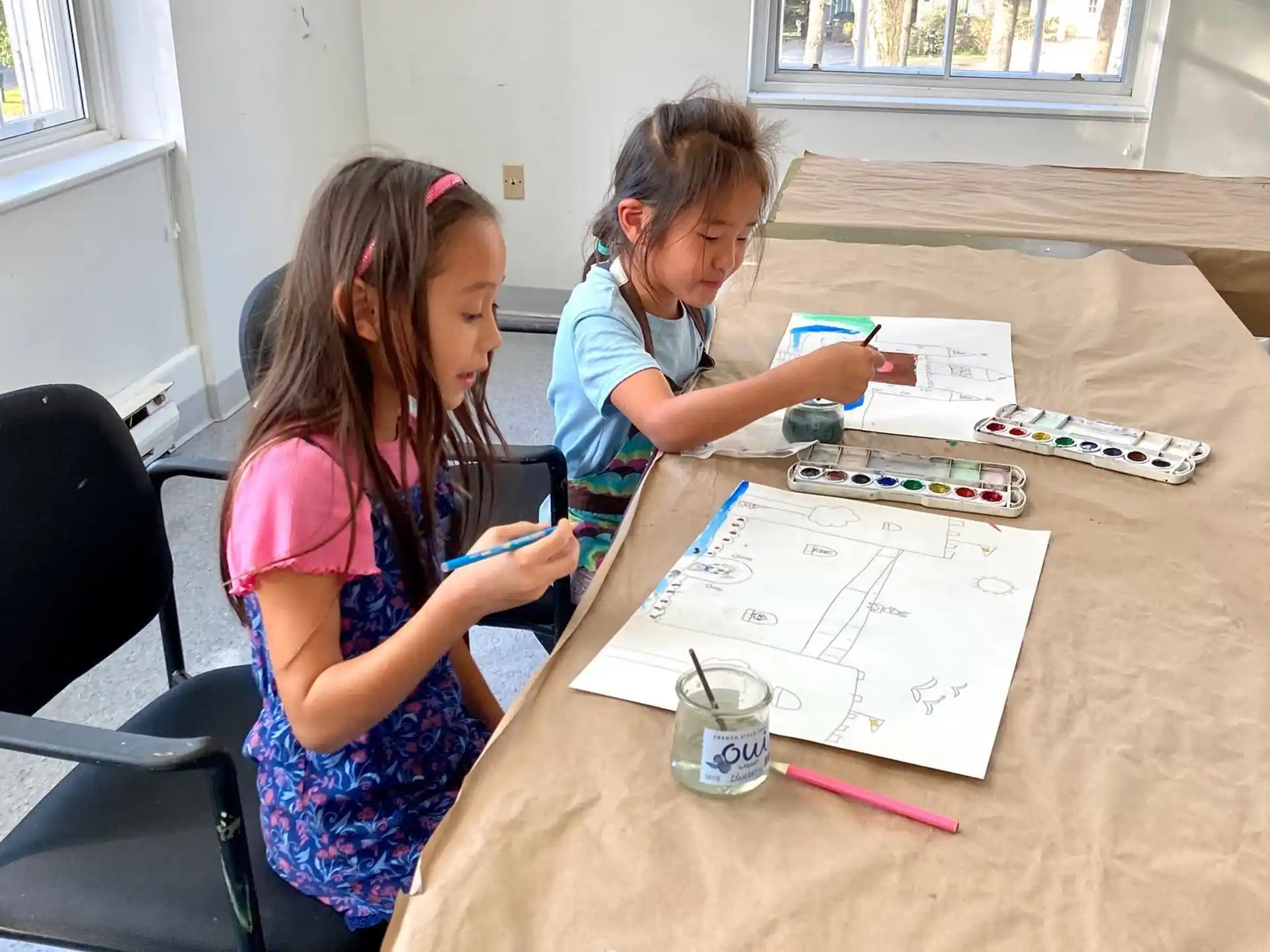 a couple of girls working on a project