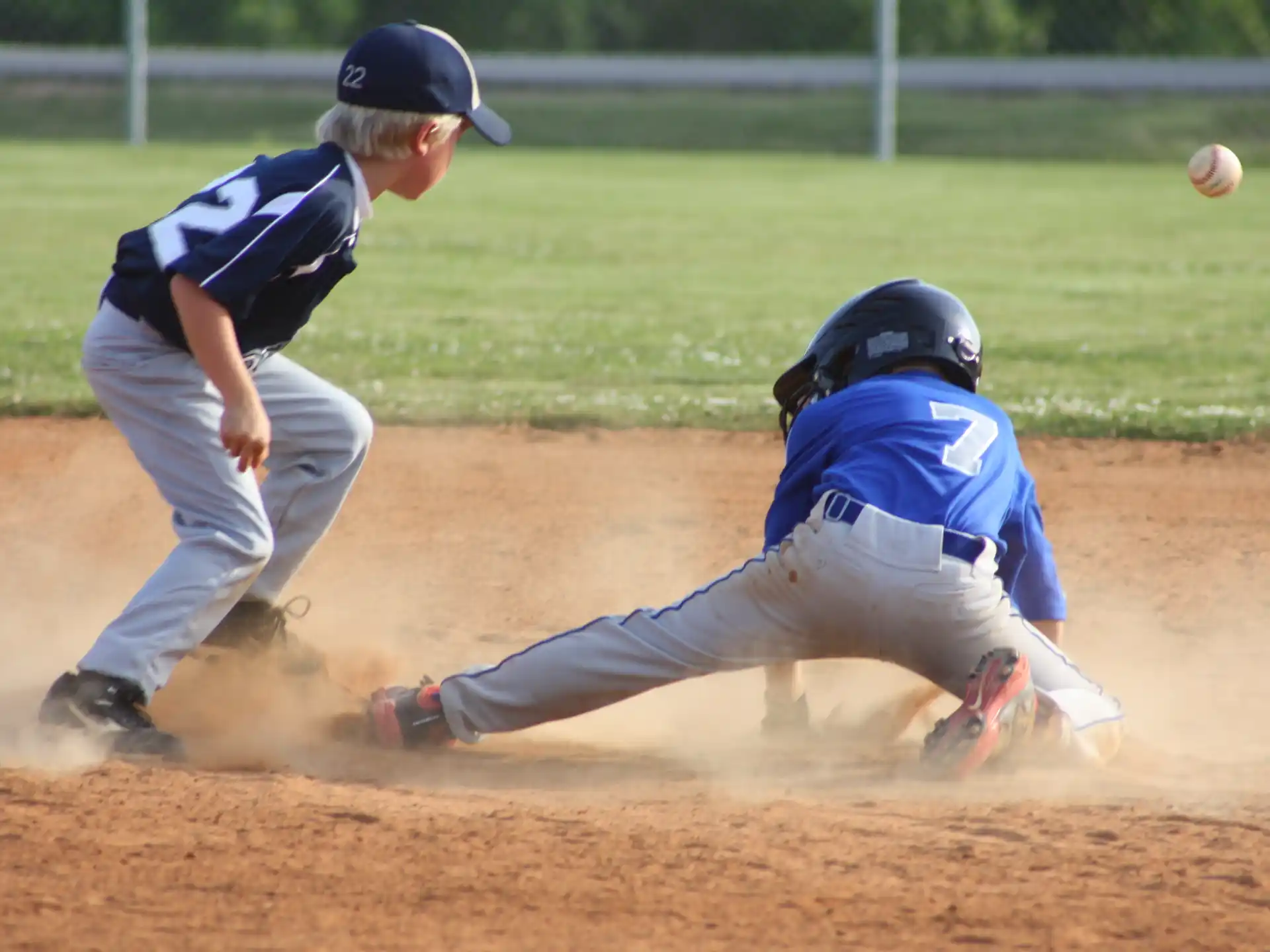 a baseball player sliding into home plate