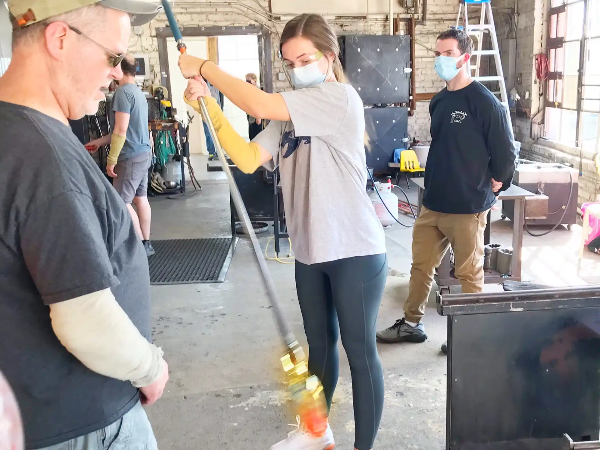 a person using a broom to blow up a fire