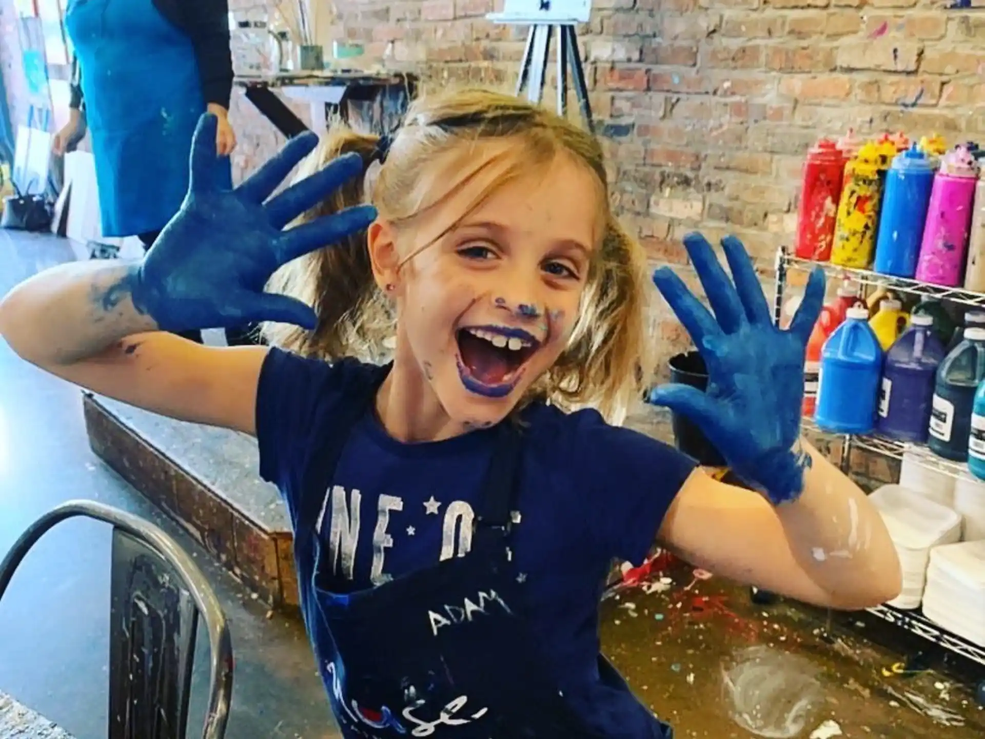 a girl in a pool with her hands up