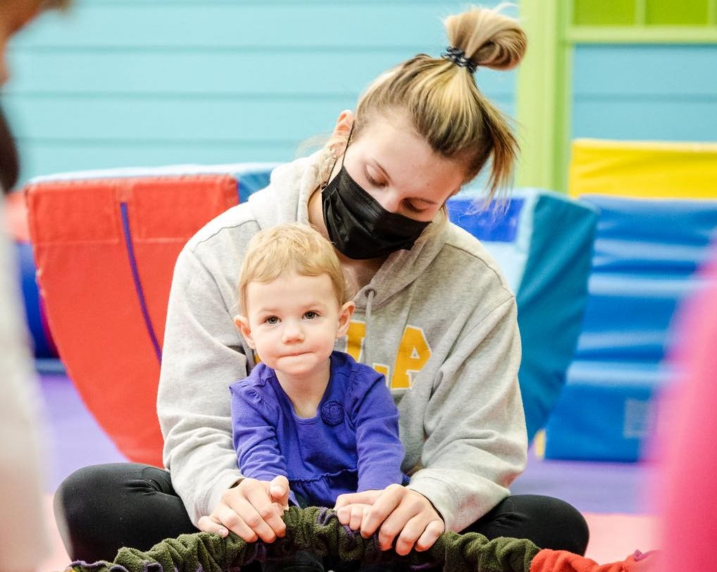 a person and a child sitting on a chair
