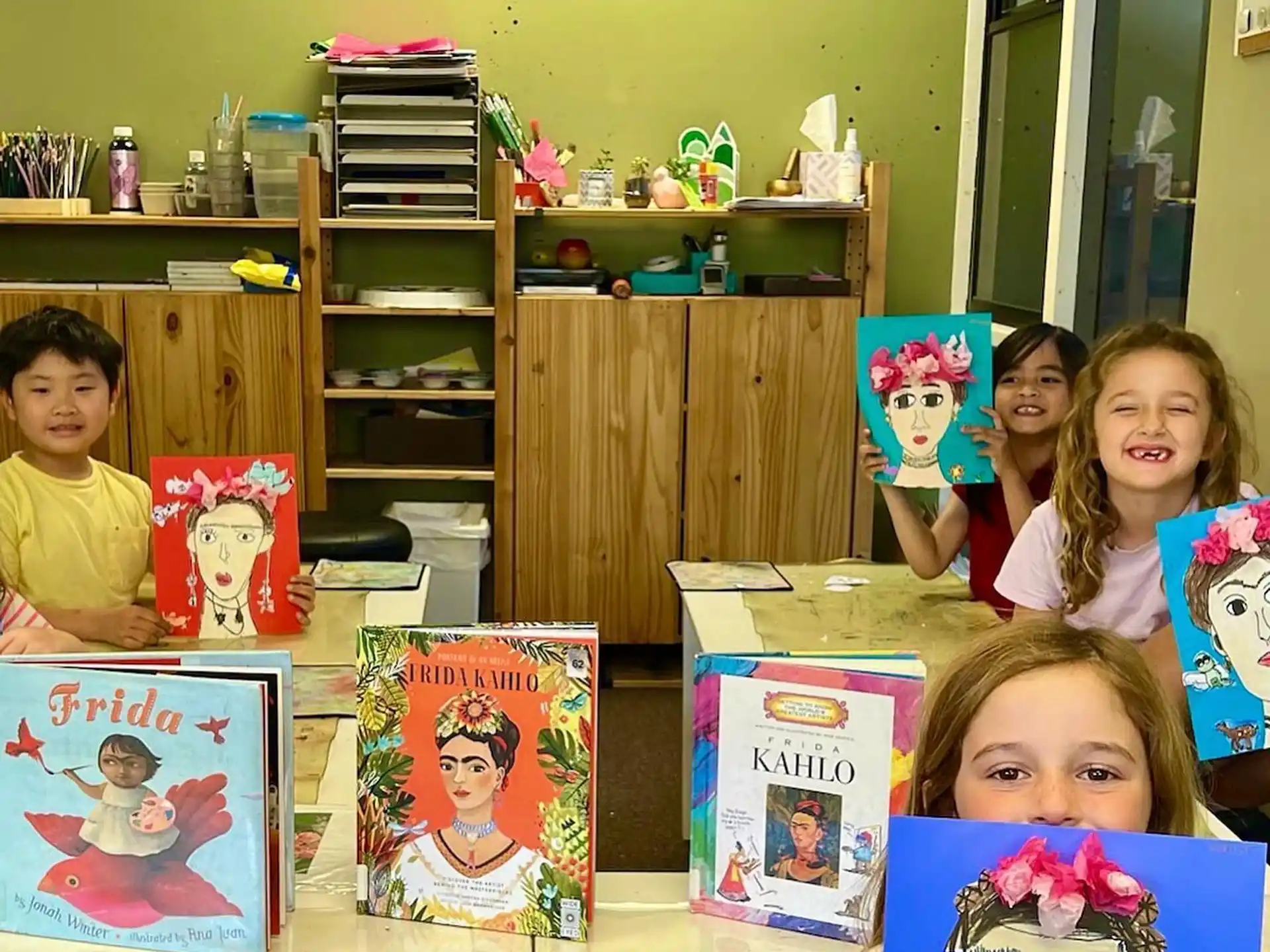 children holding books in a room