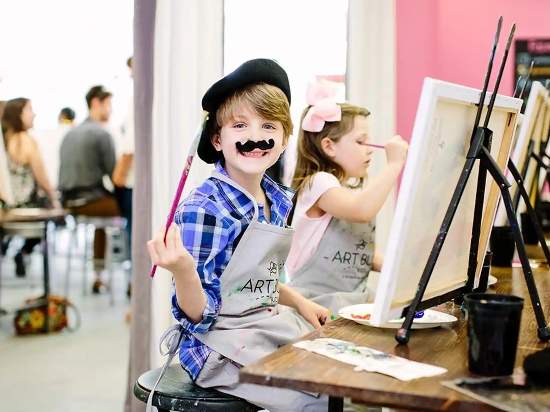 a person with a fake mustache holding a girl with a fake mustache