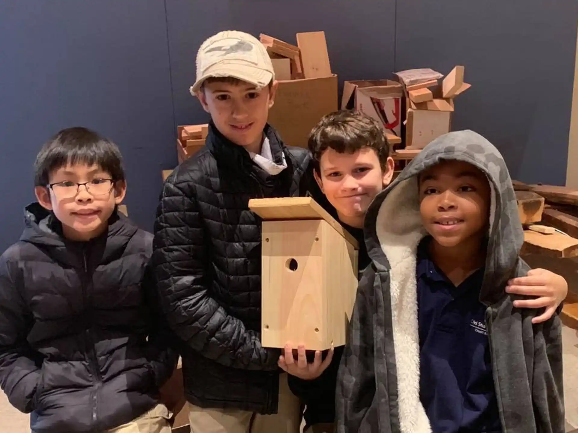 a group of boys holding boxes
