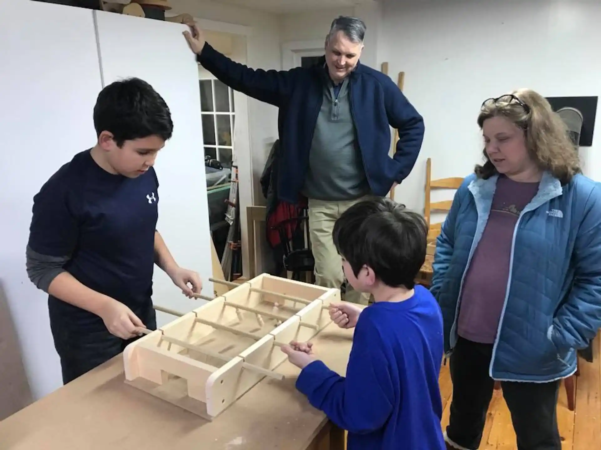 a group of people looking at a cardboard box