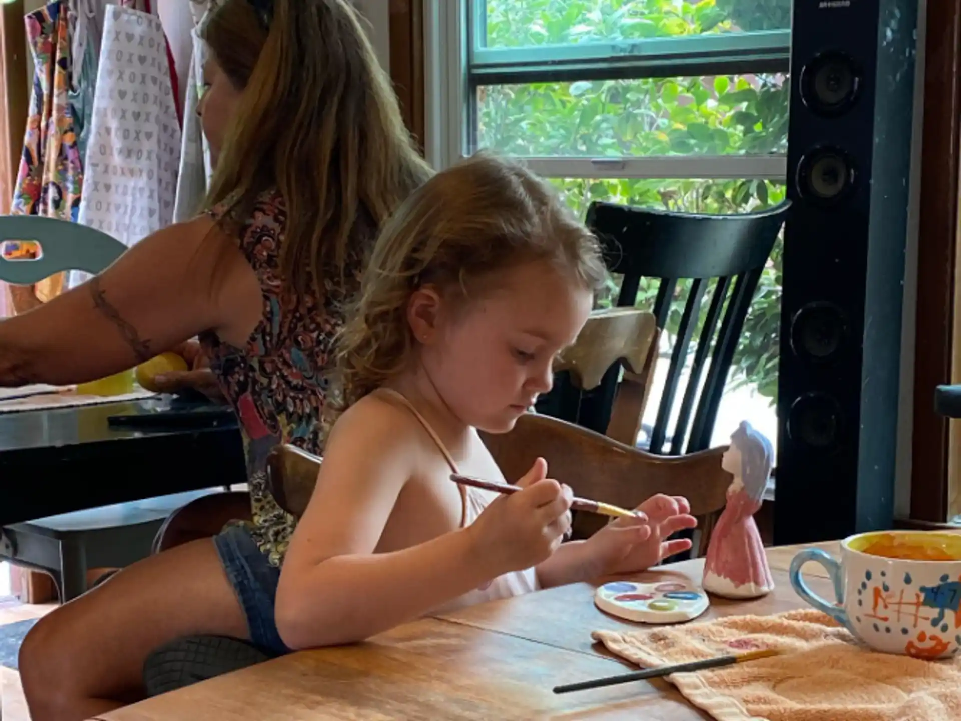 a woman and a child painting