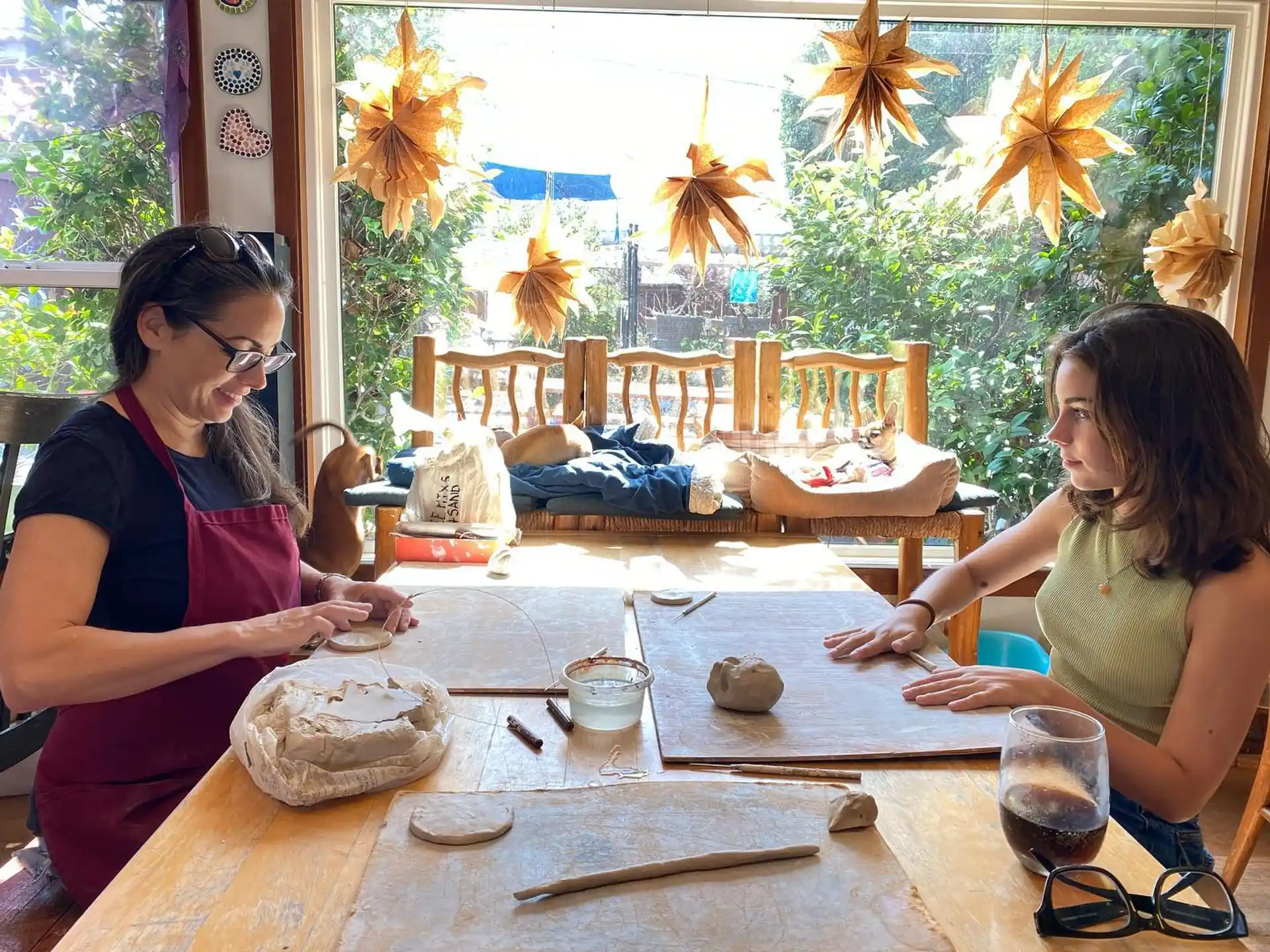 a woman and a girl sitting at a table with food