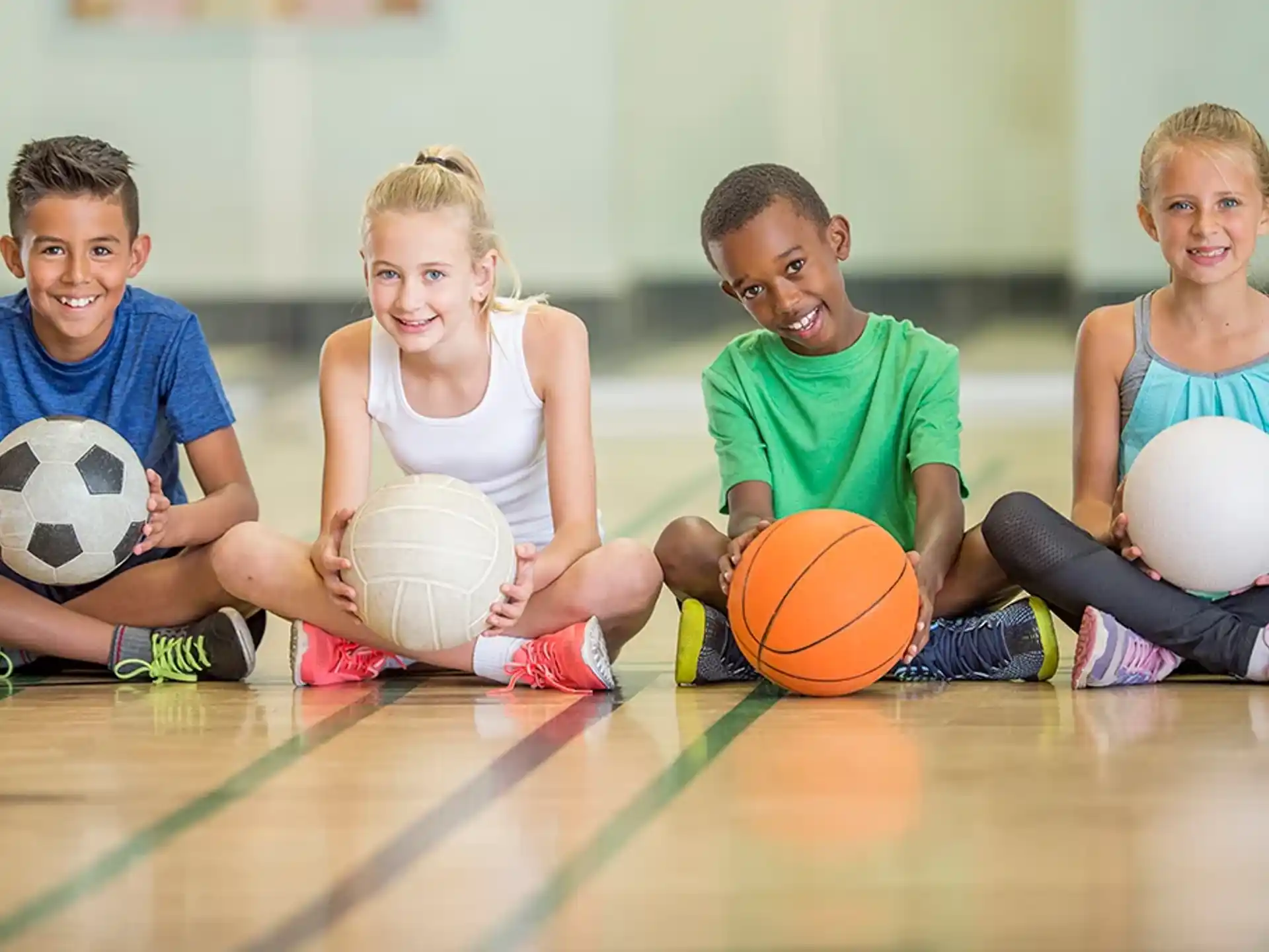 a group of kids holding balls