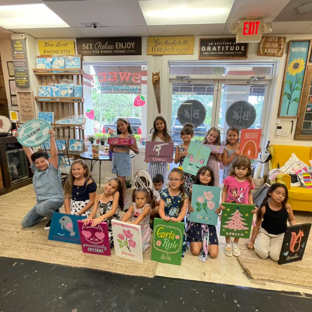 a group of people holding boxes posing for the camera