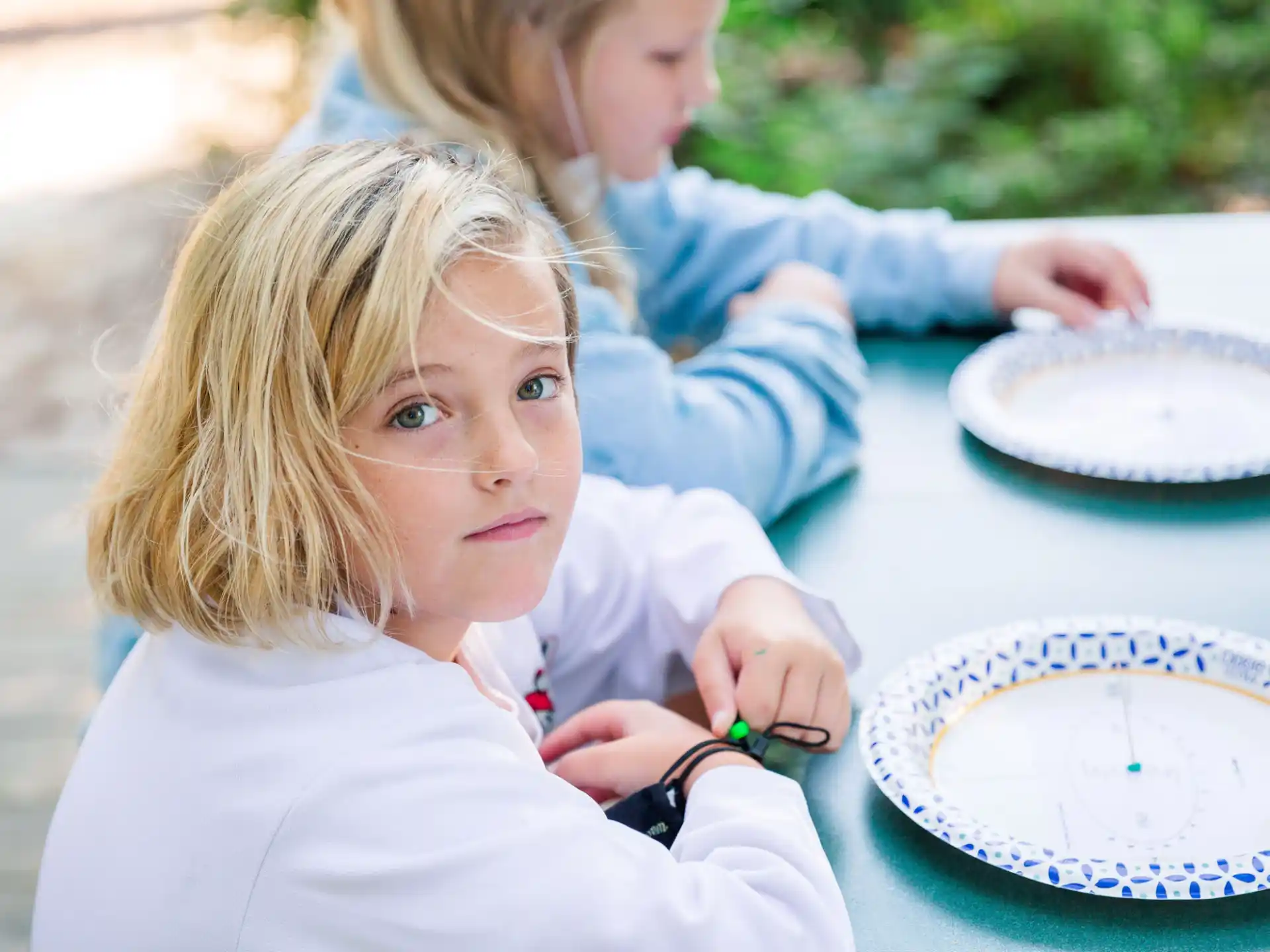 a young girl cutting a cake