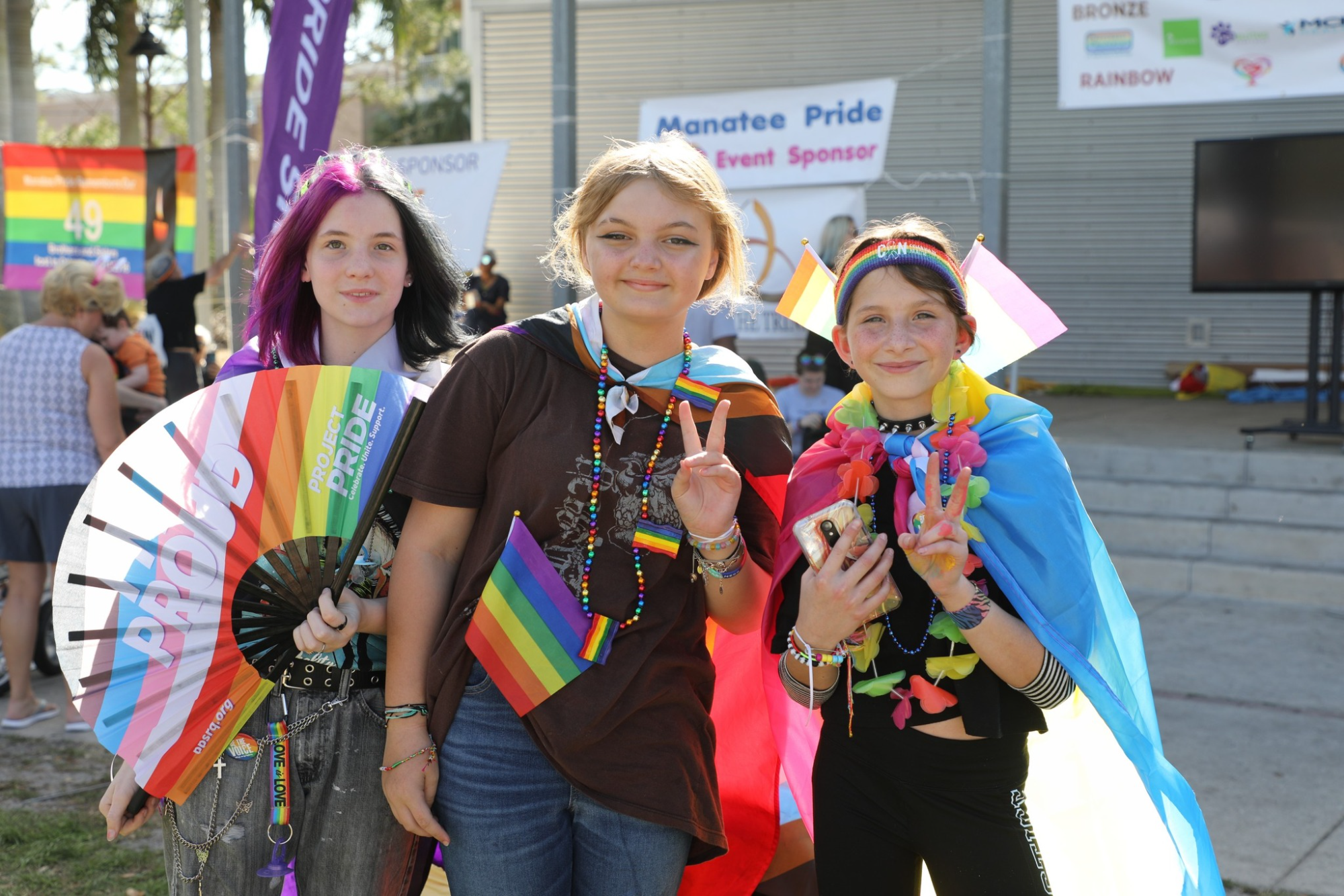 a group of women holding up a peace sign
