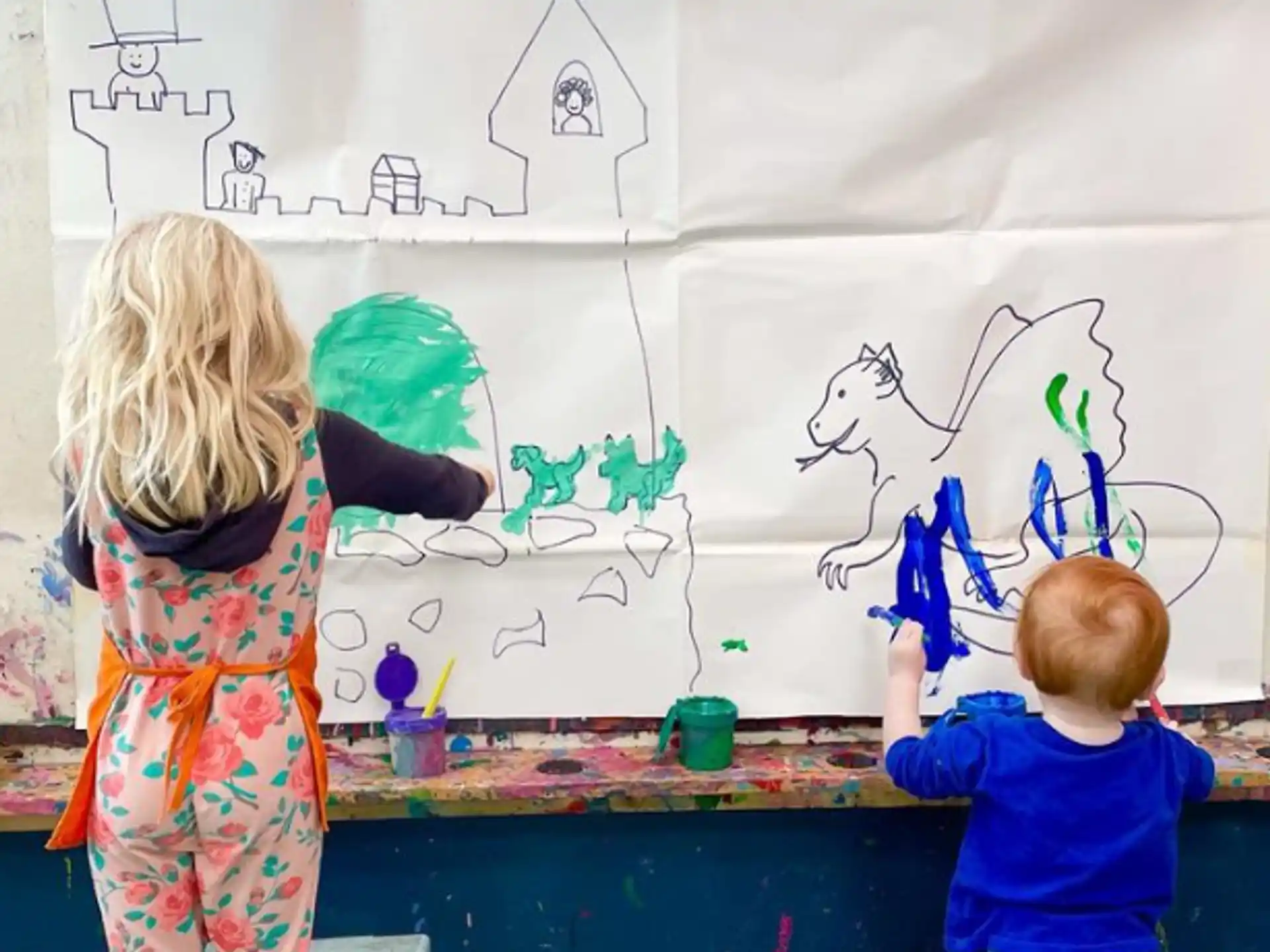 children painting on a white board