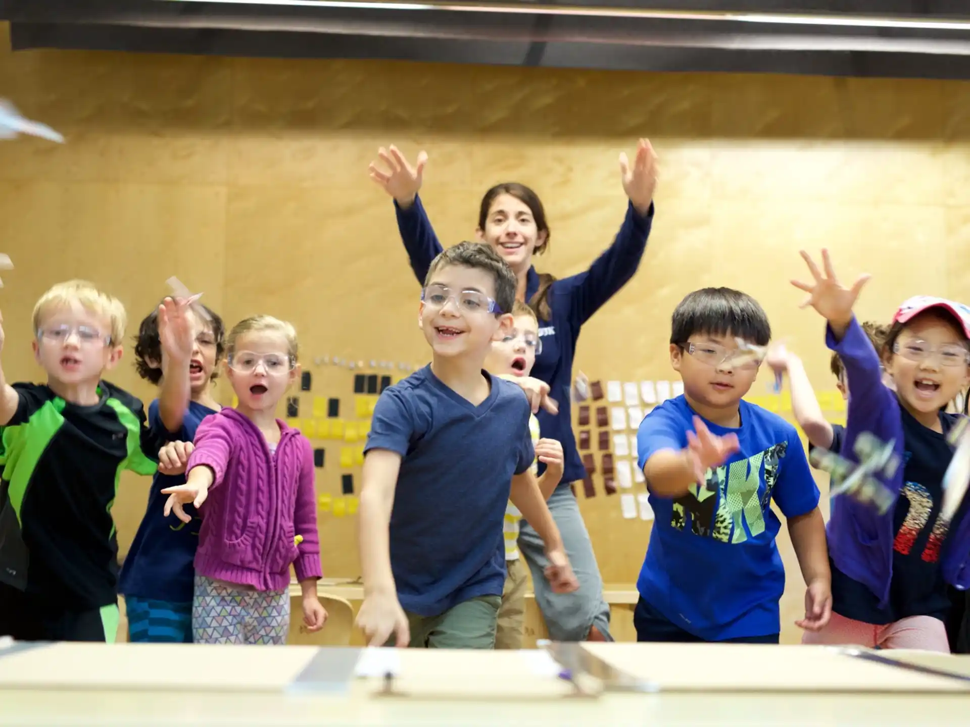 a group of children raising their hands