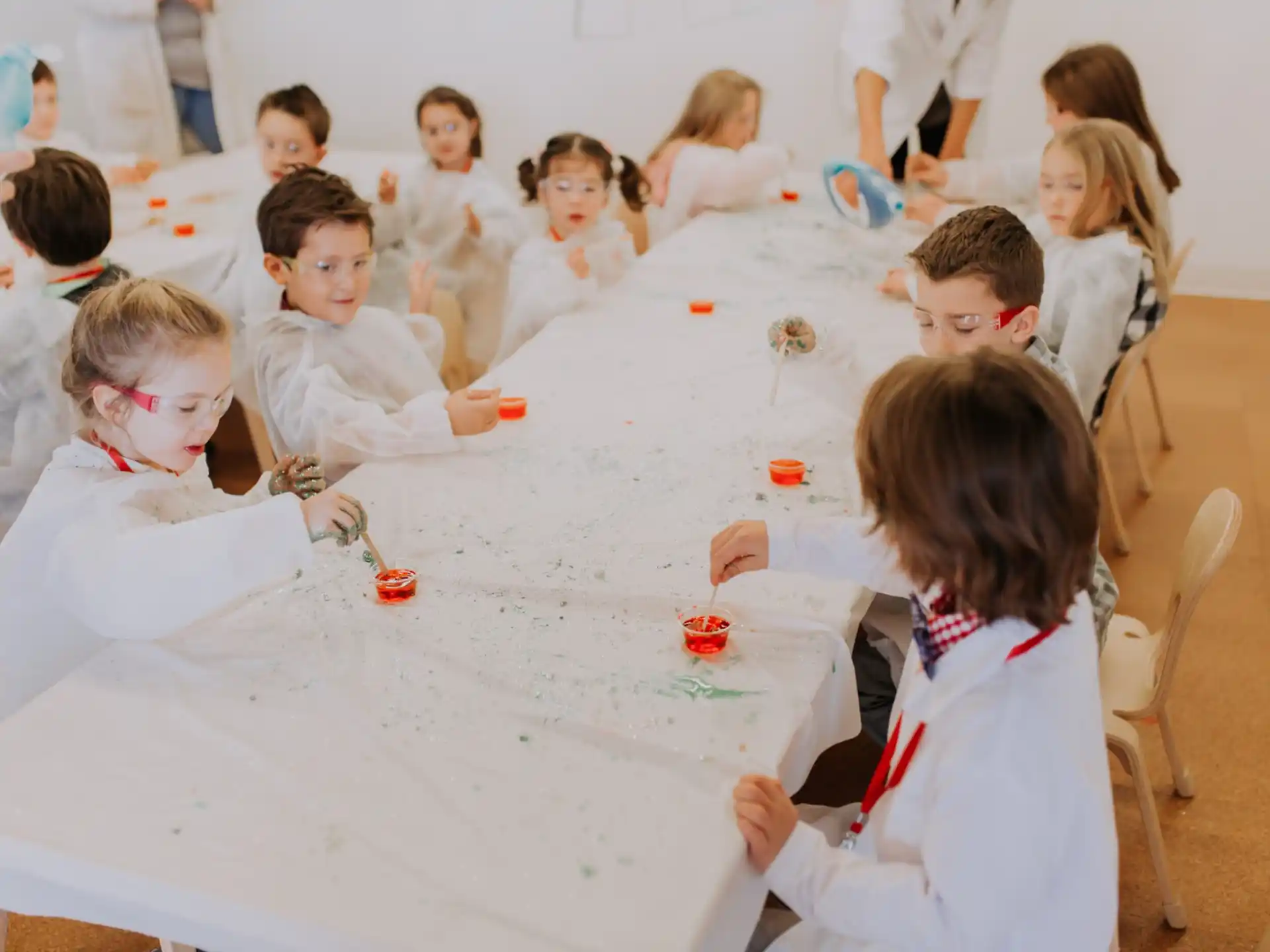 a group of children sitting around a table