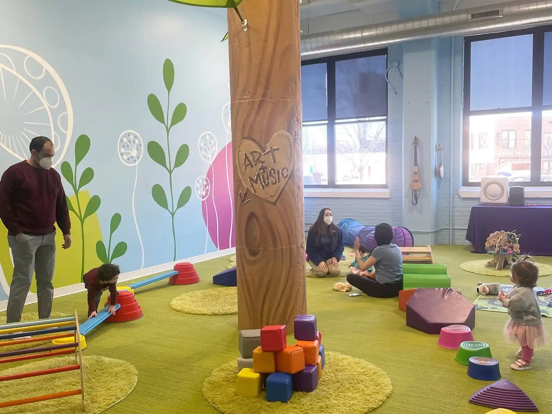 a group of people playing on a colorful floor
