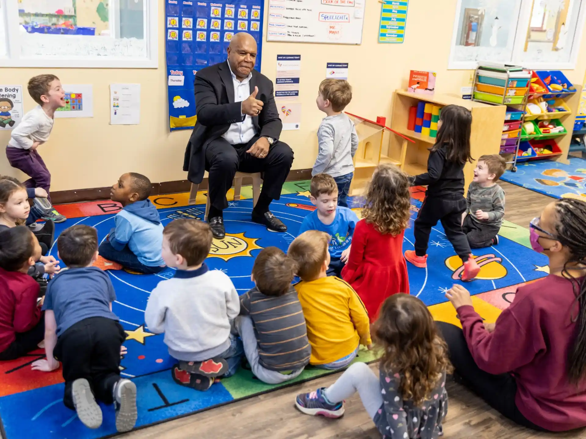 a person sitting in front of a group of children