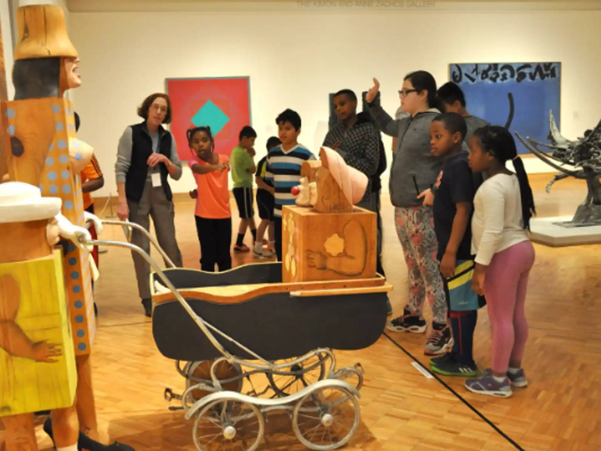 a group of people standing in a room with a skeleton and a skeleton