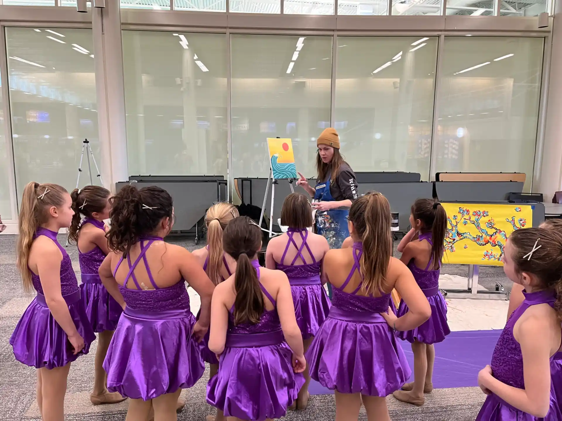 a group of girls in purple dresses