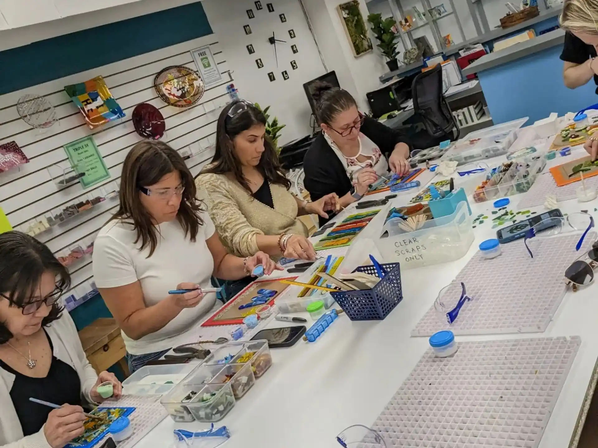 a group of people sitting at a table with many pieces of paper