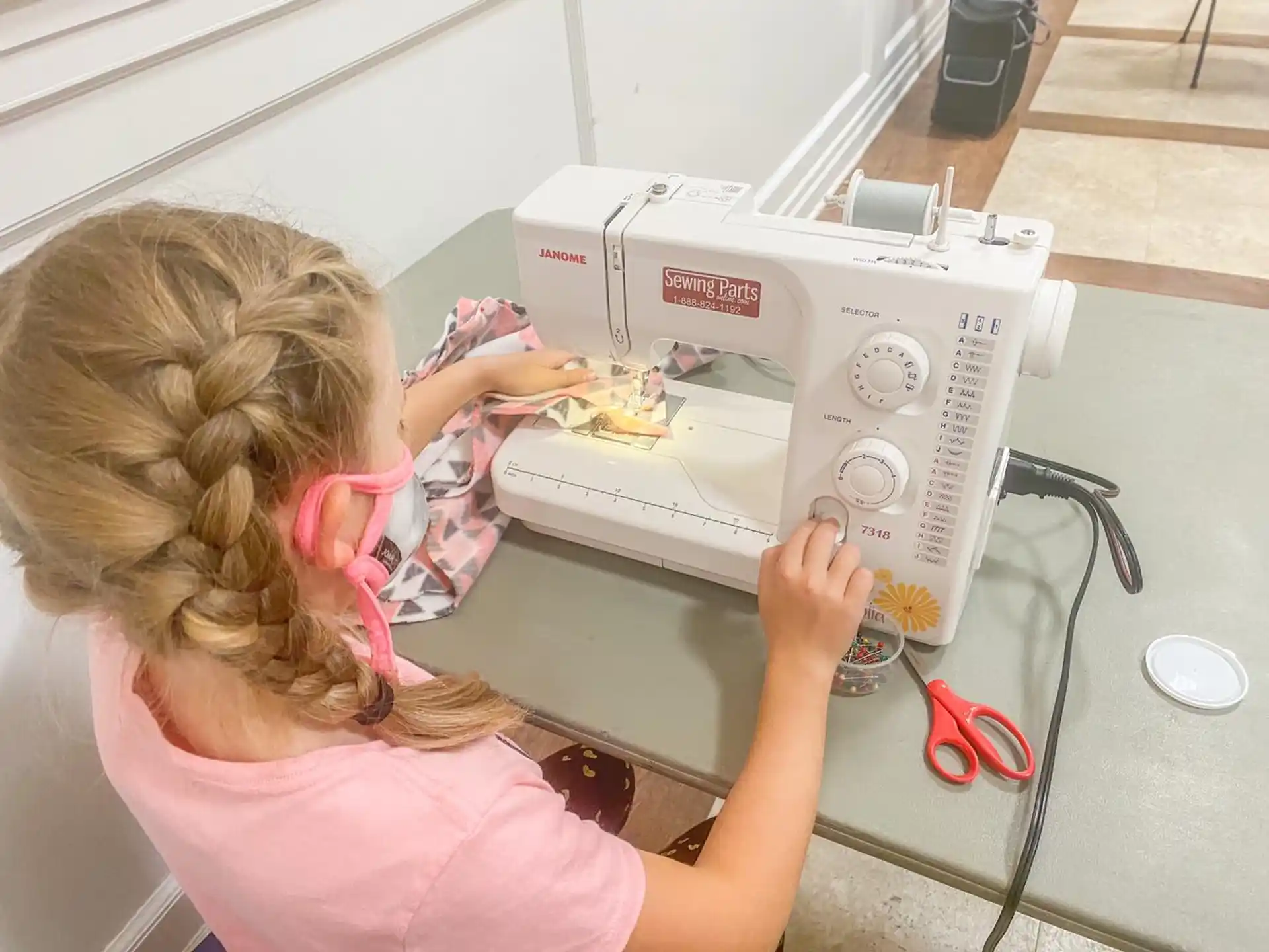 a girl using a sewing machine
