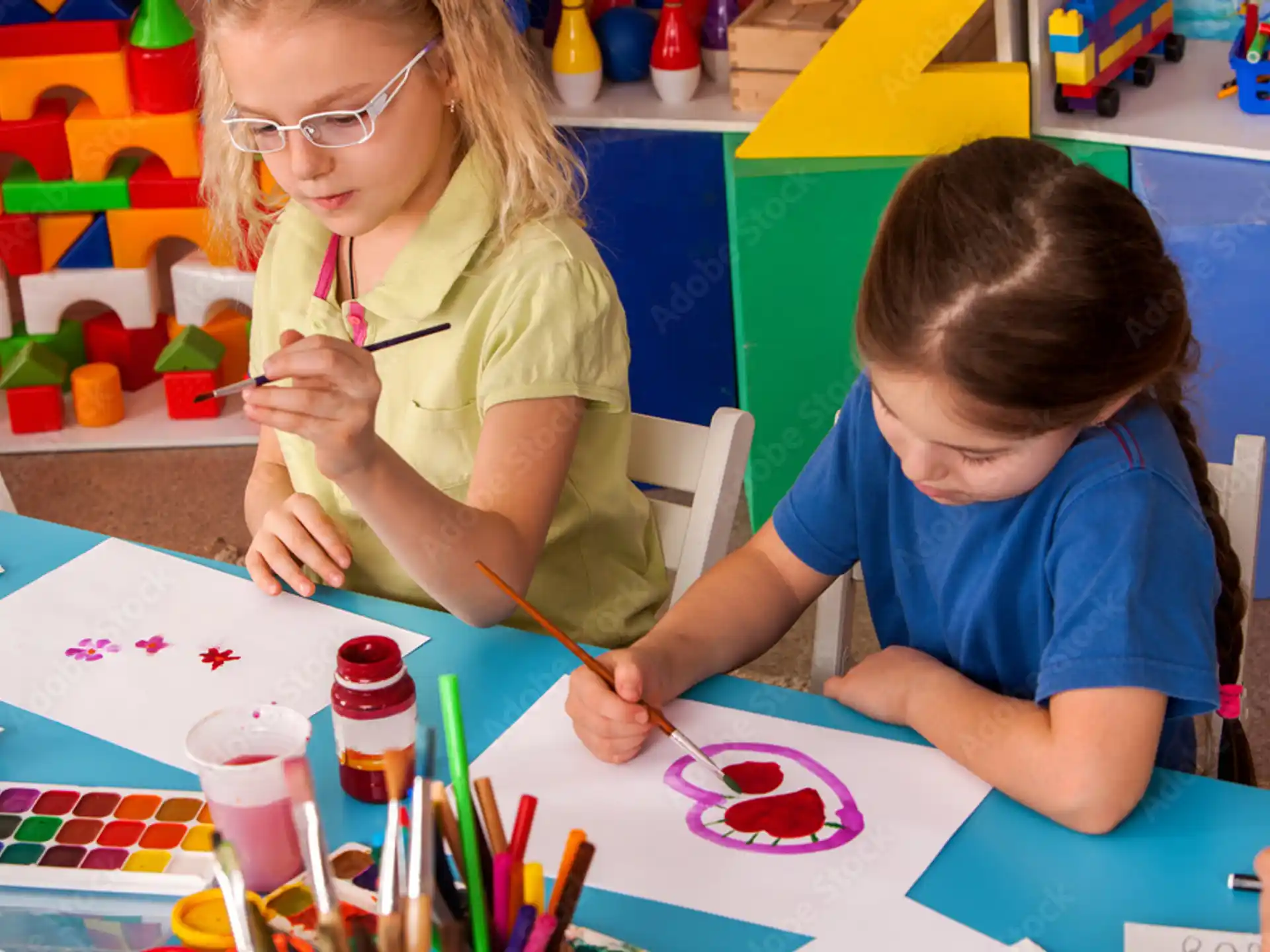a person and a child painting