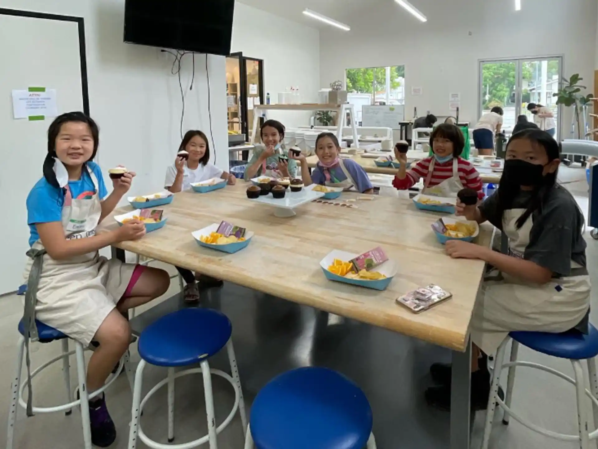 a group of children sitting around a table