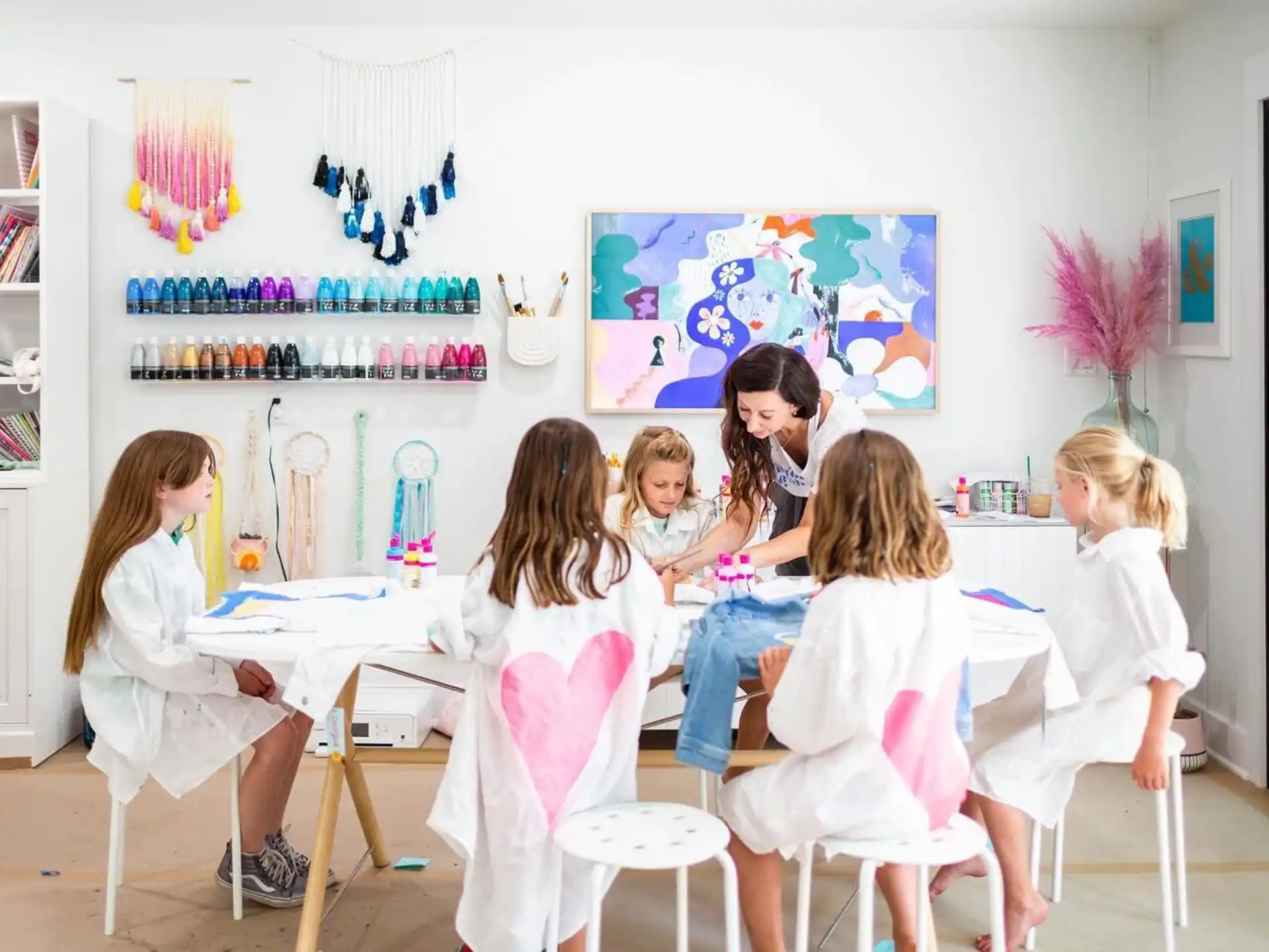 a group of children sitting around a table