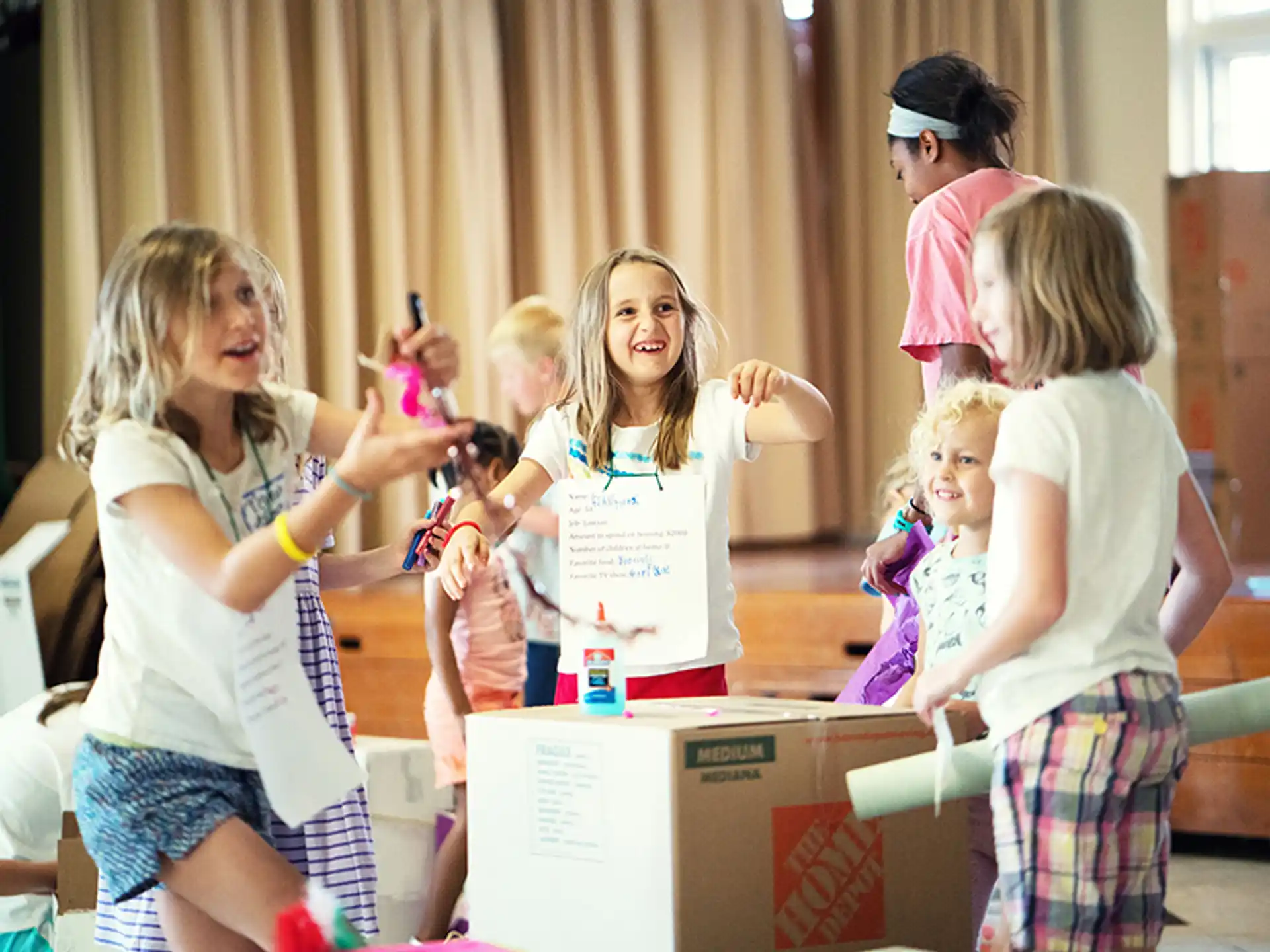 a group of children standing around a box