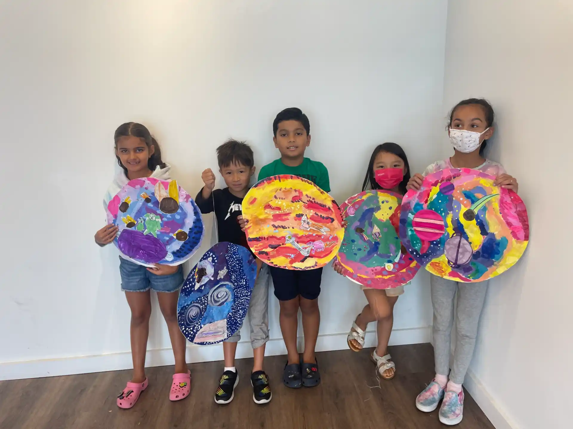 a group of children holding up colorful signs