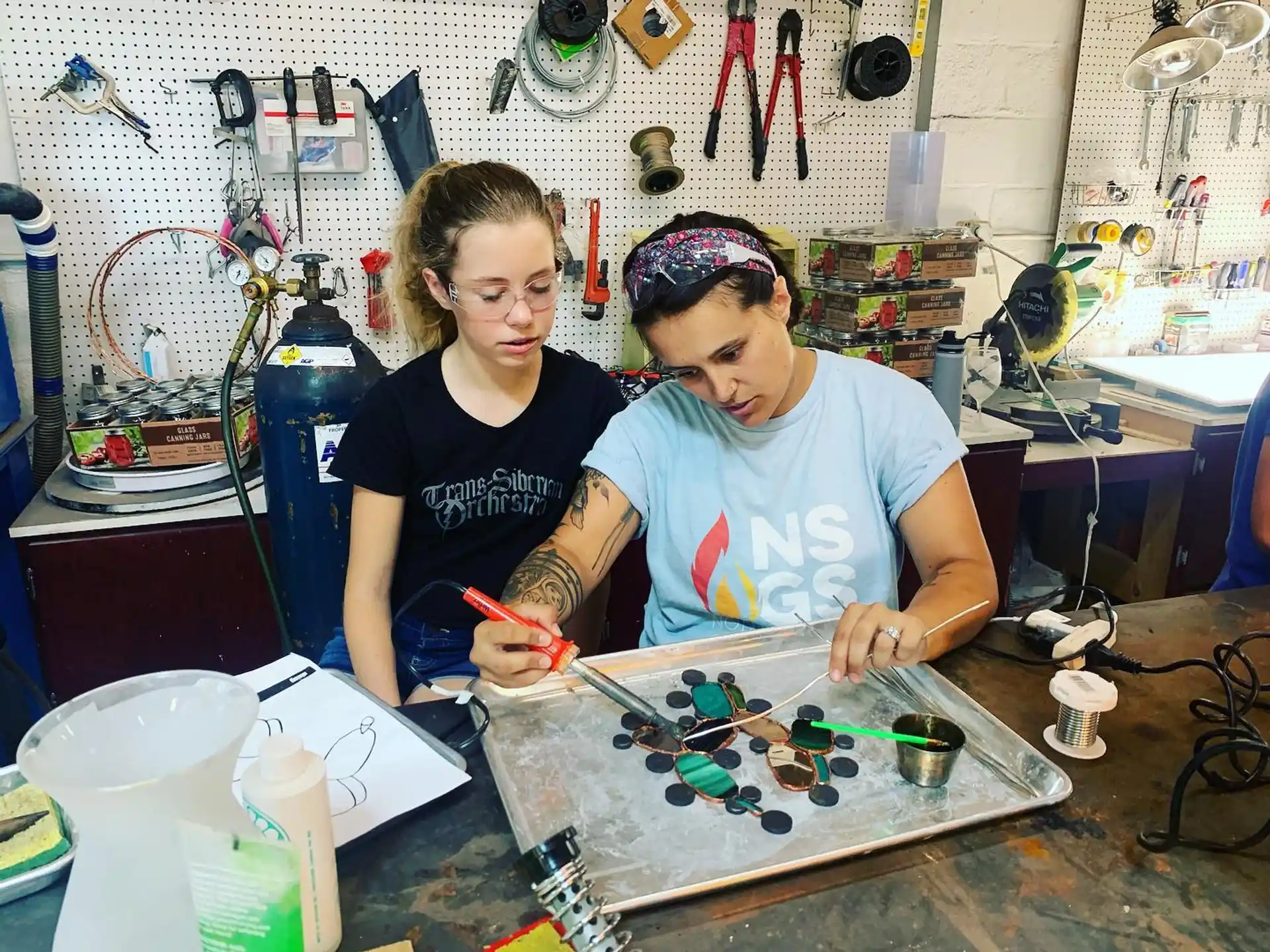 a couple of women working on a project