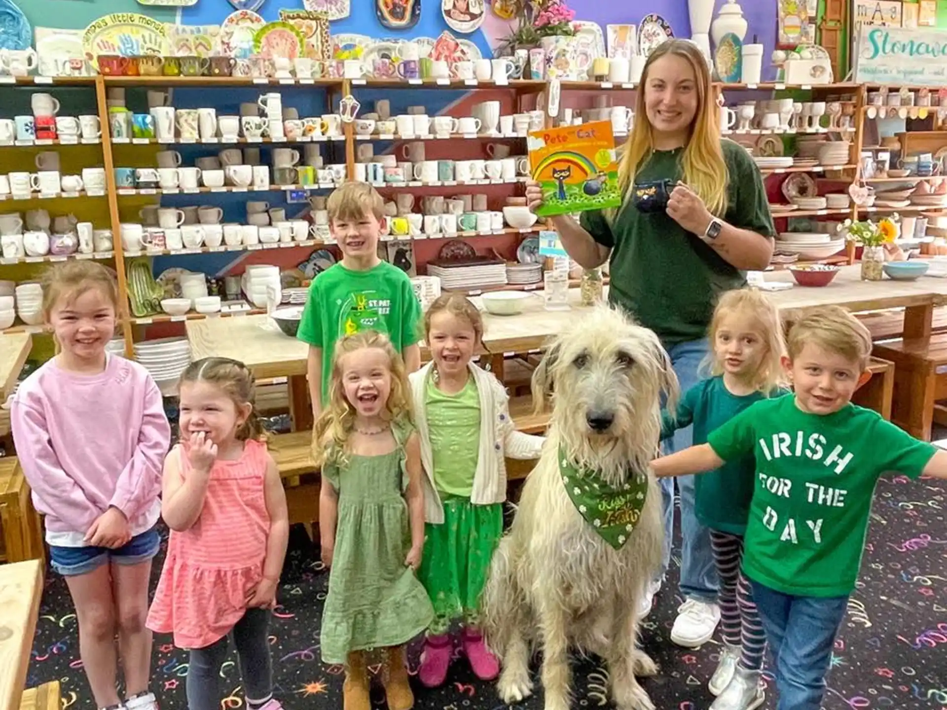 a group of children and a dog in a room with shelves