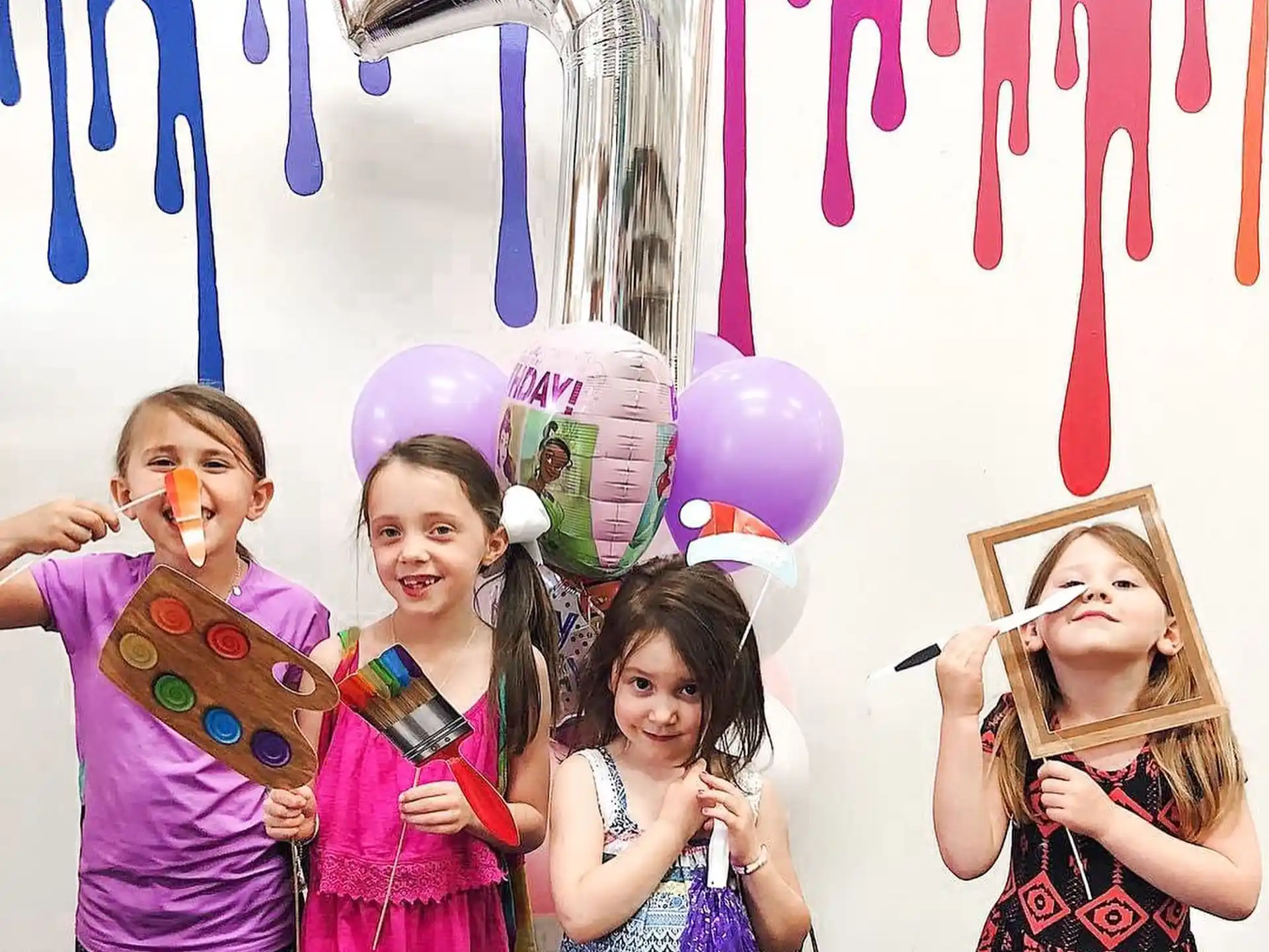 a group of girls holding balloons