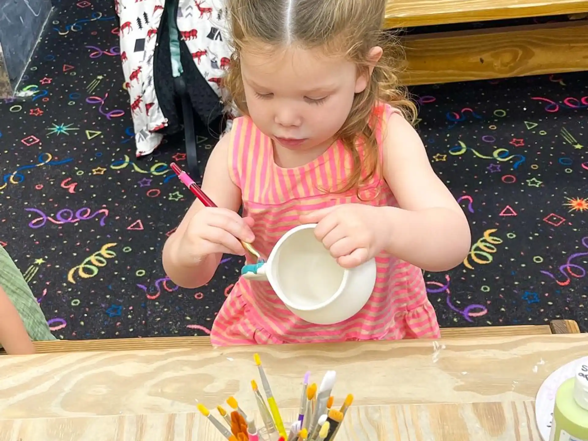 a little girl eating from a bowl