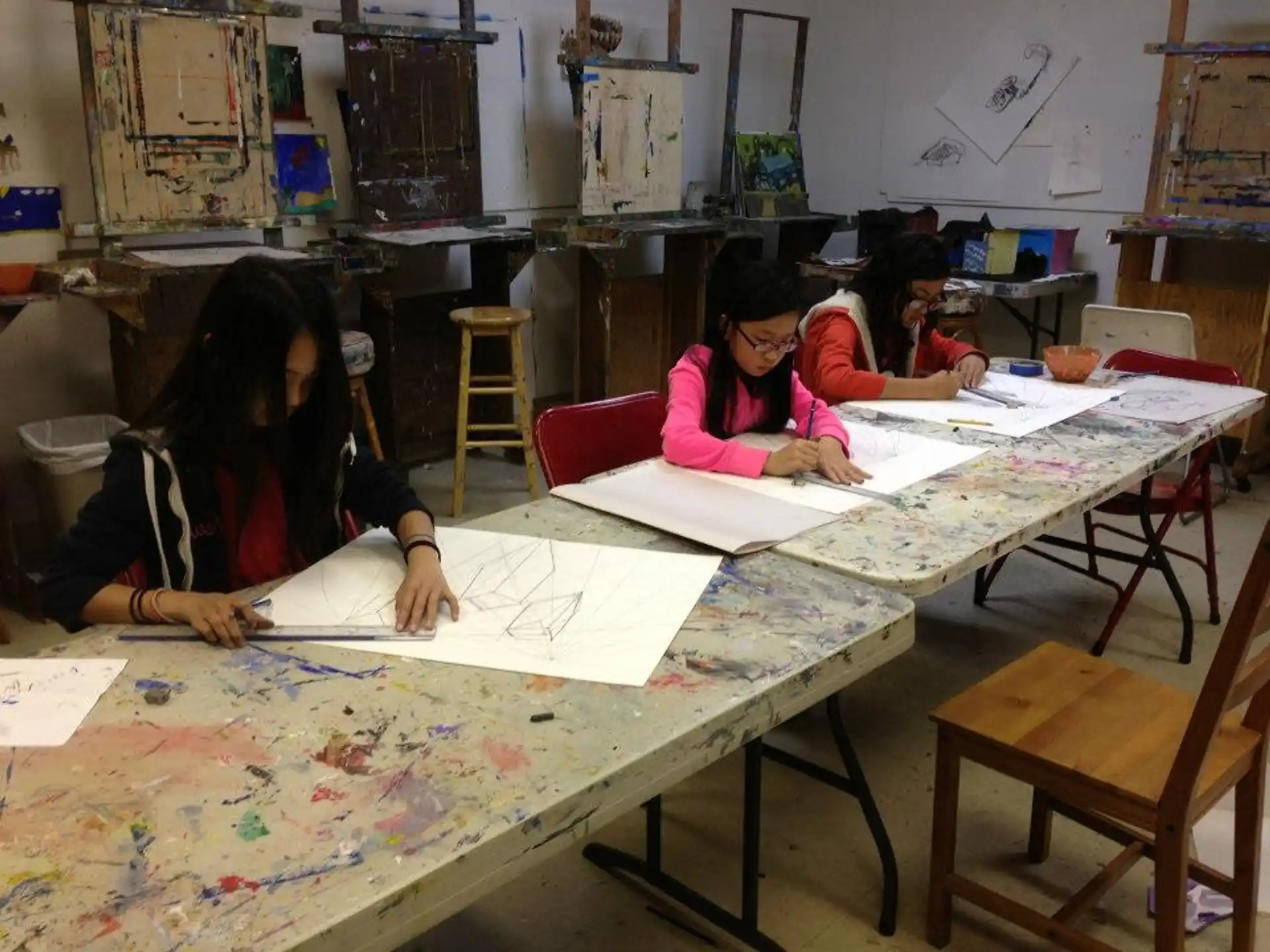 a group of women sitting at a table with papers on it