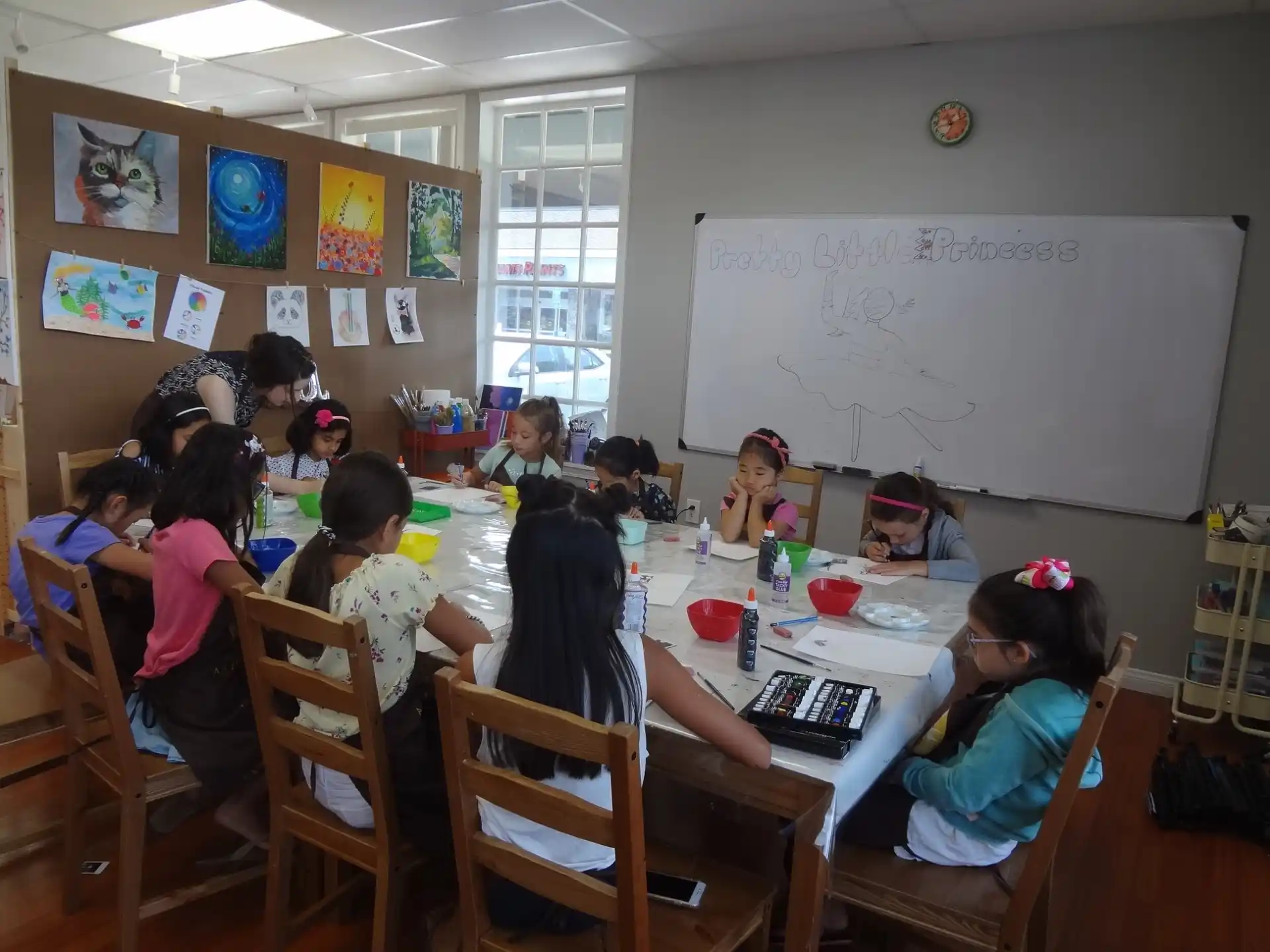 a group of children sitting around a table